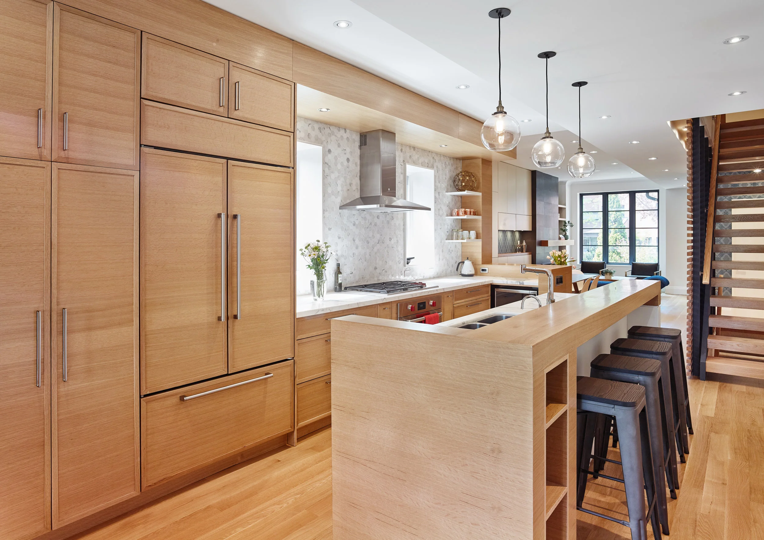 By including built-in appliances such as the fridge, it keeps with the clean seamless look.