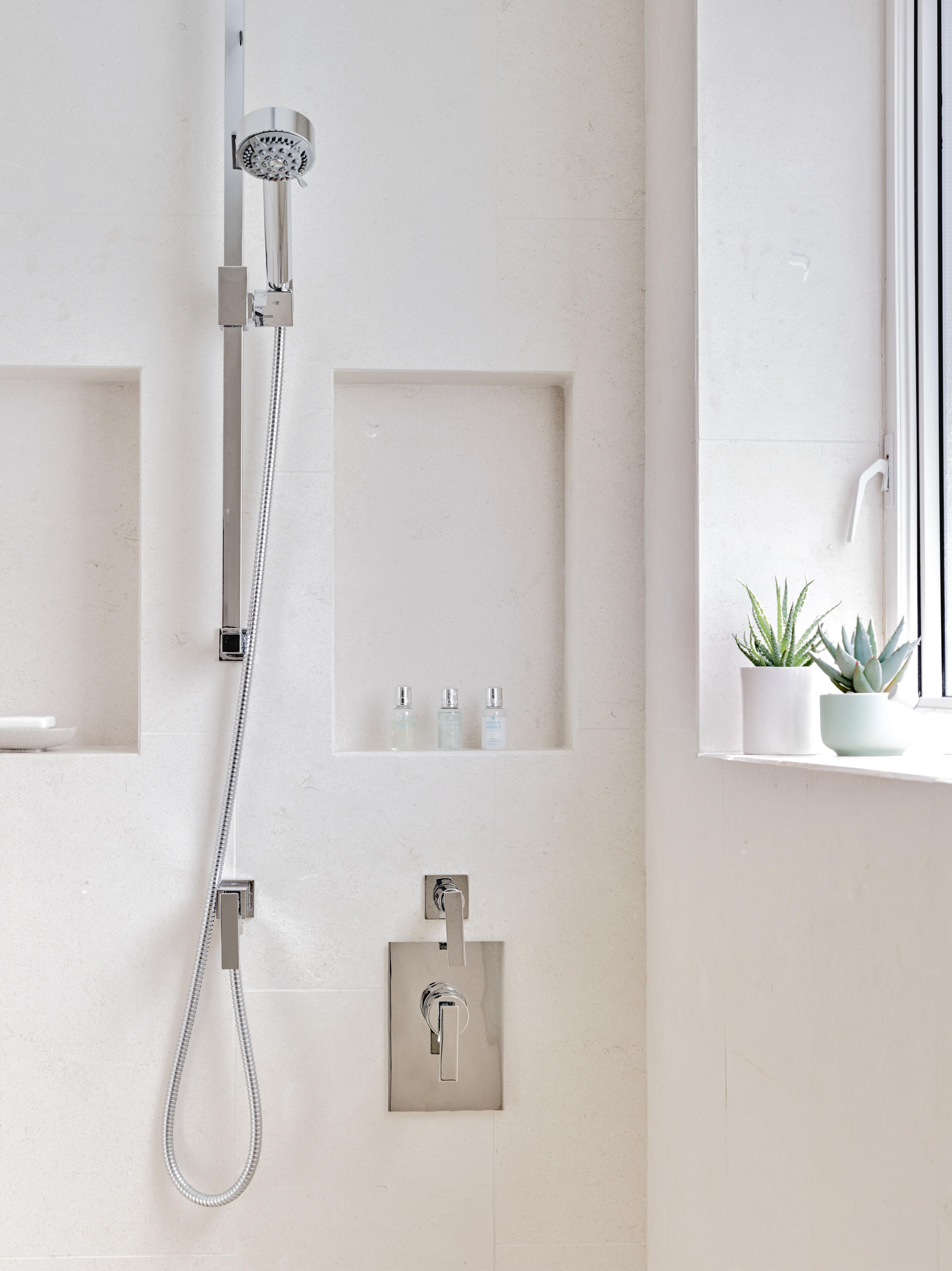 More niche shelving that was carefully tiled creates beautiful functional storage in the shower.