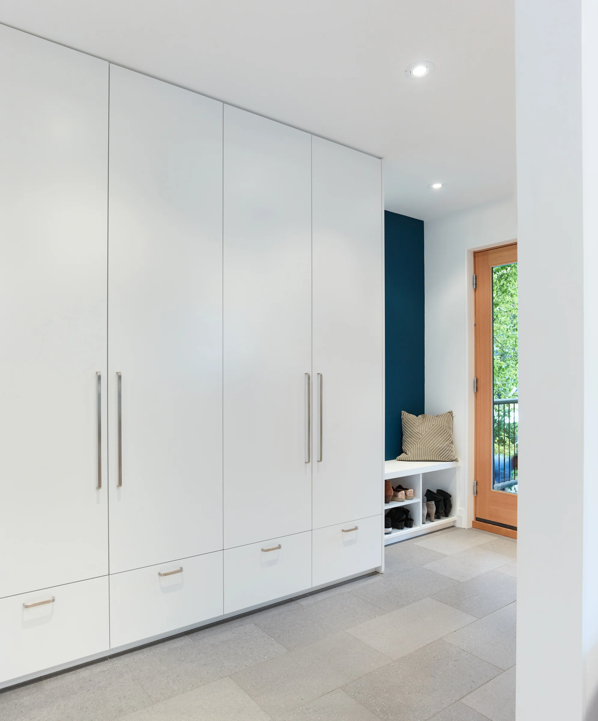An inset bench by the front door provides space for shoe storage.