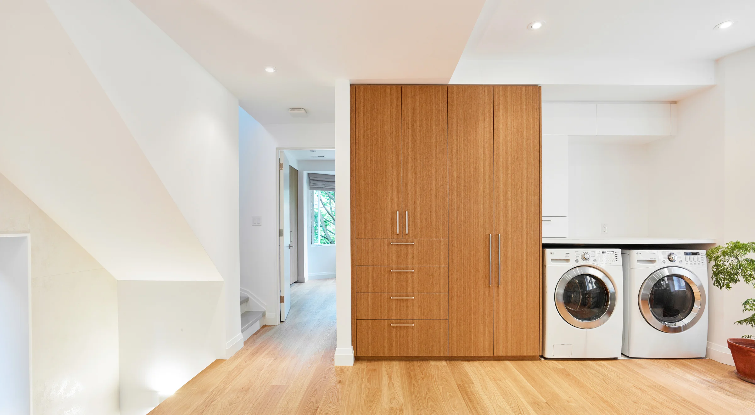 Upstairs, a den serves many functions: as an office/workspace, play area for the kids, and laundry area.