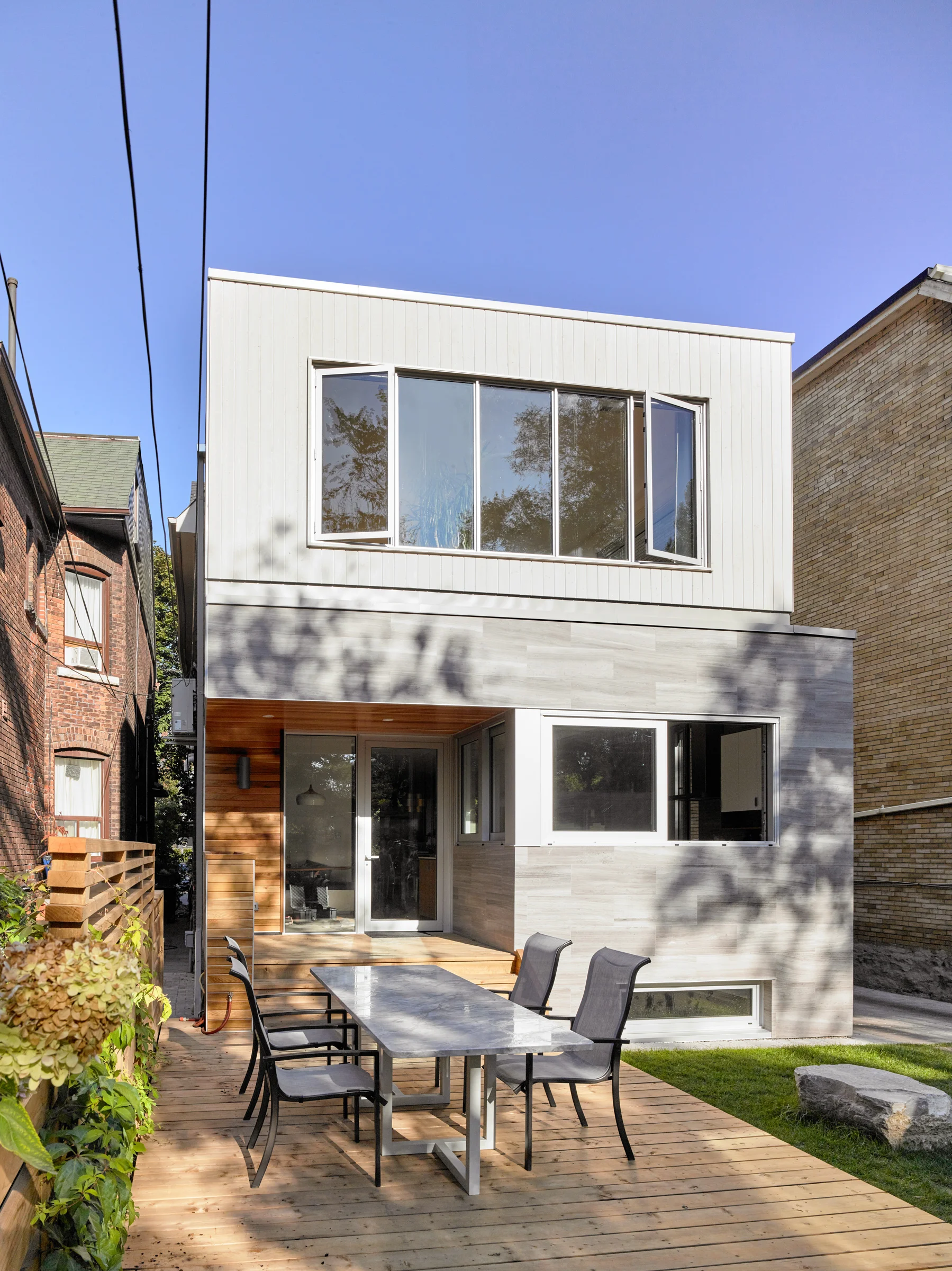 A custom granite table and metal base was designed to complement the exterior cladding materials.