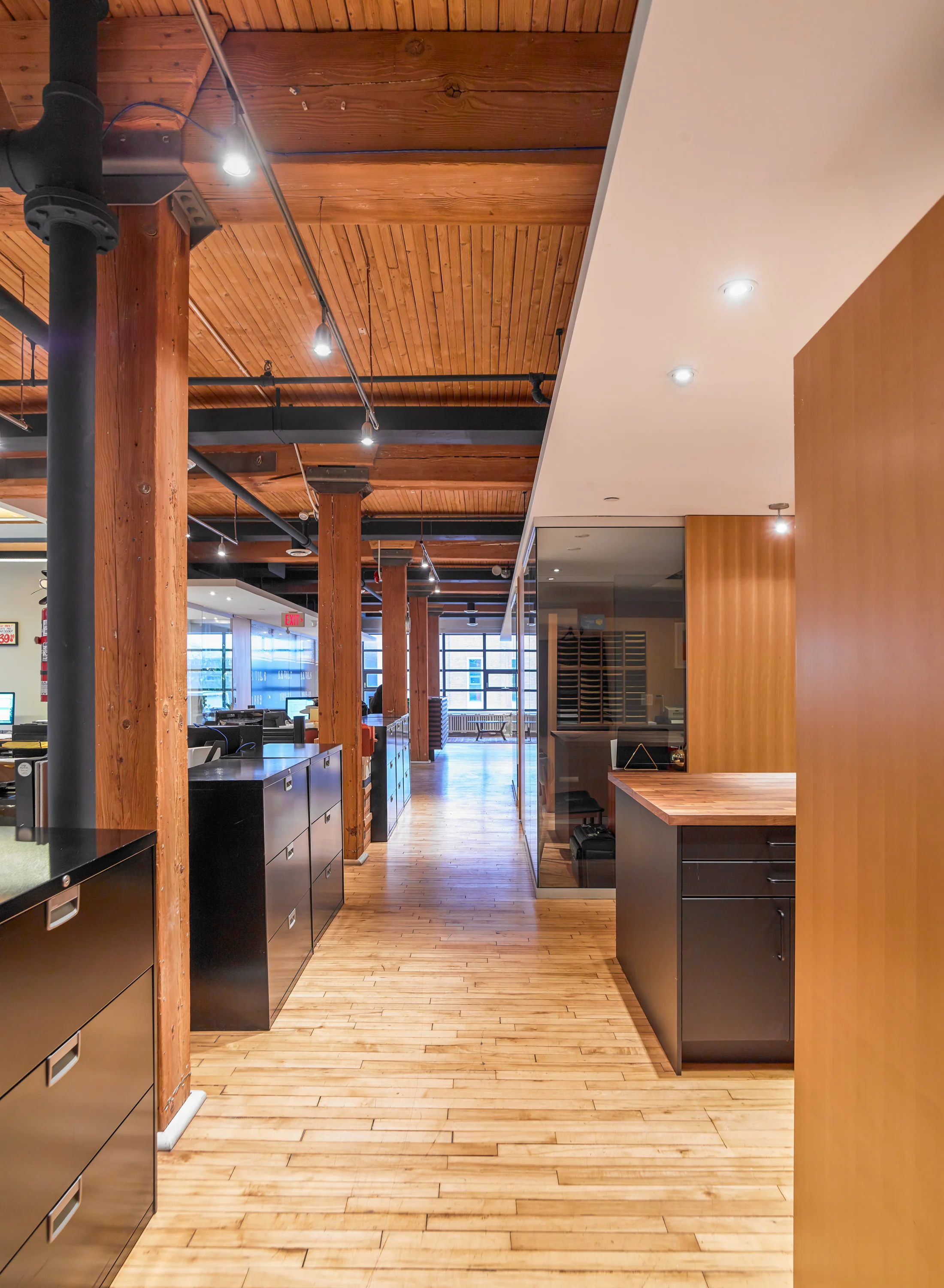 The wood structure's richness is contrasted against floating planes of crisp drywall.