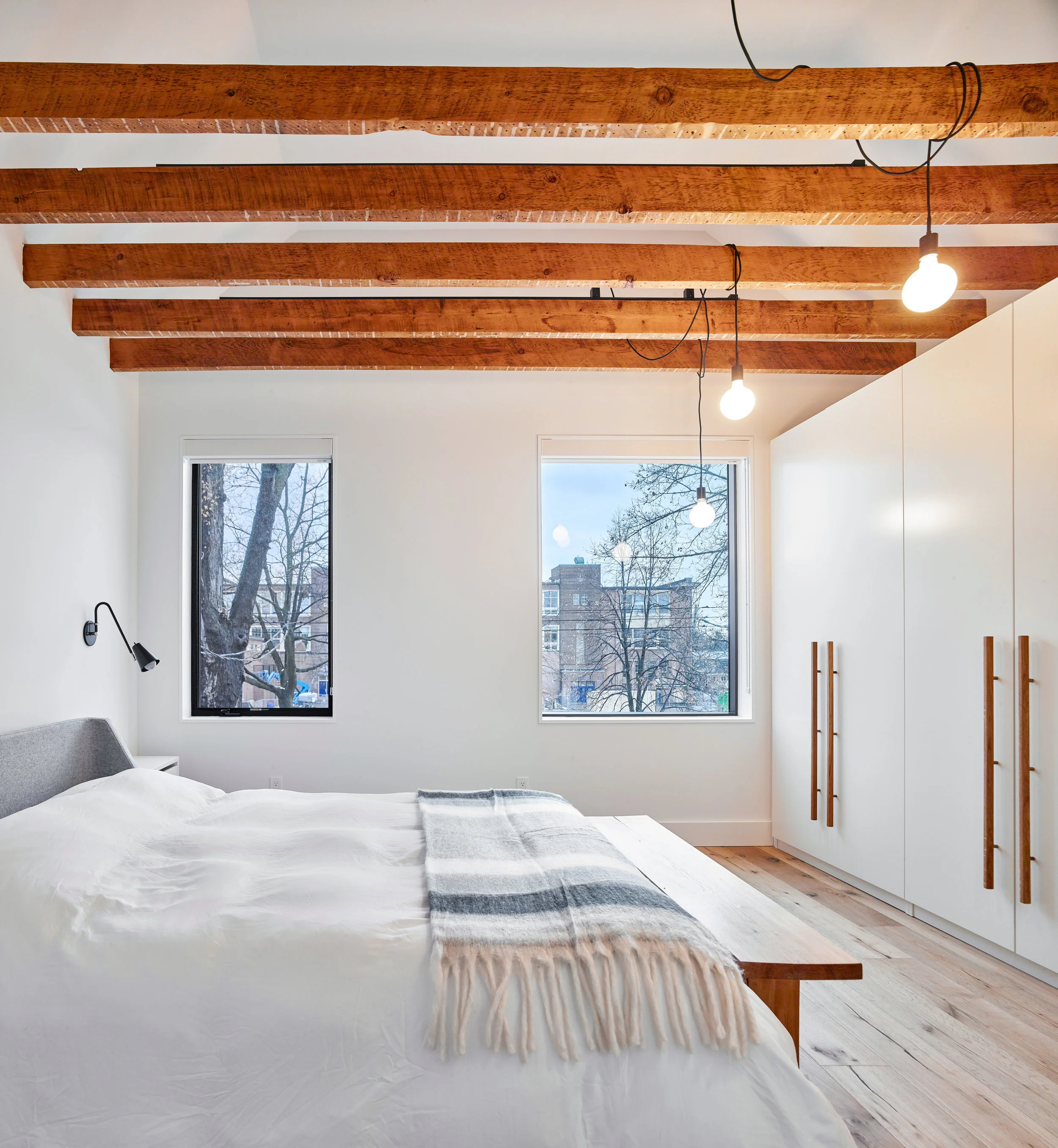 Exposed joists continue through the master bedroom, but at a denser spacing which creates a sense of coziness and enclosure, within a grand bedroom with vaulted 12’ ceilings.