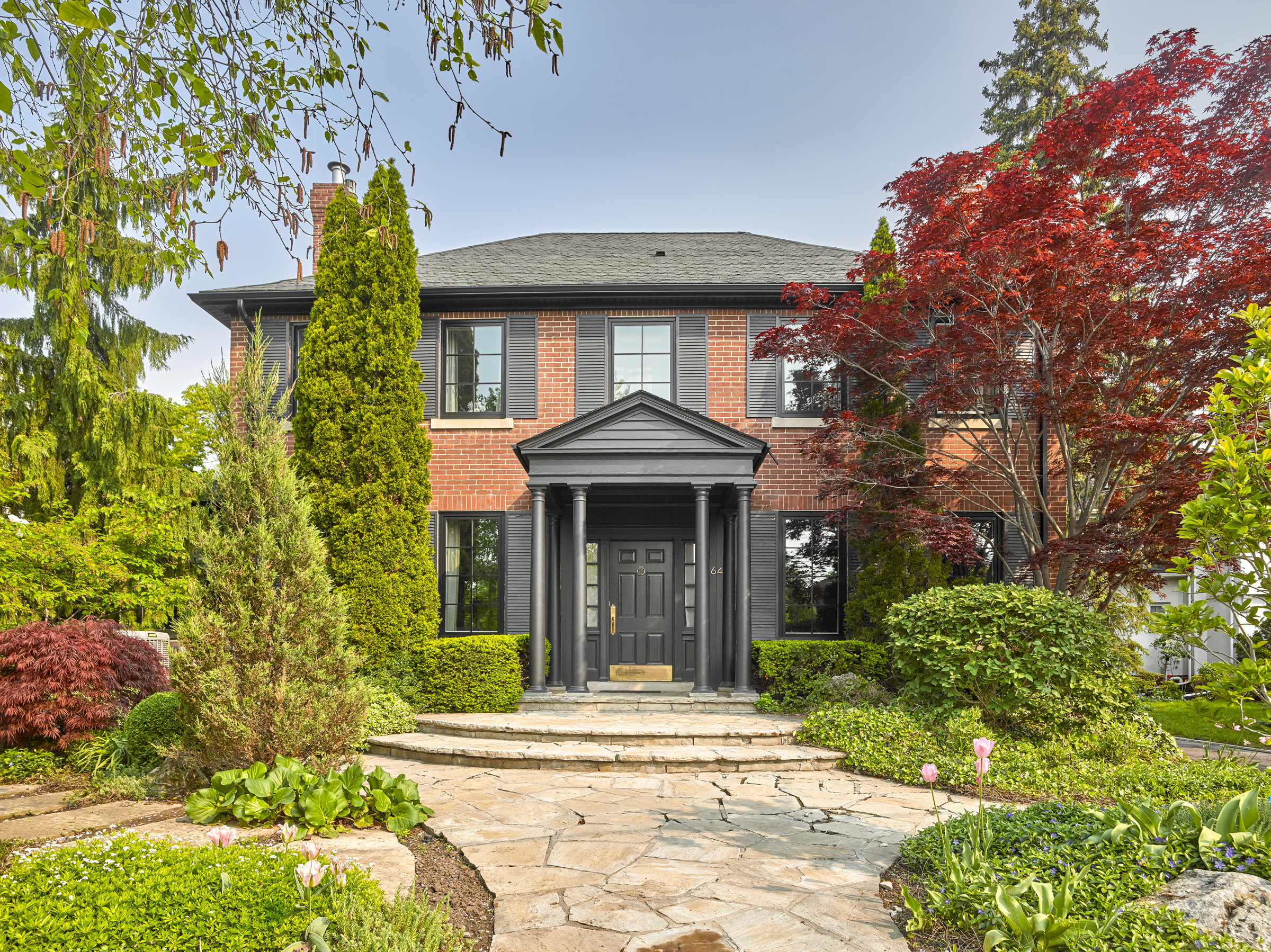Thoughtful updates to the front facade bring a sense of cohesion to the home, set within a beautifully established garden.