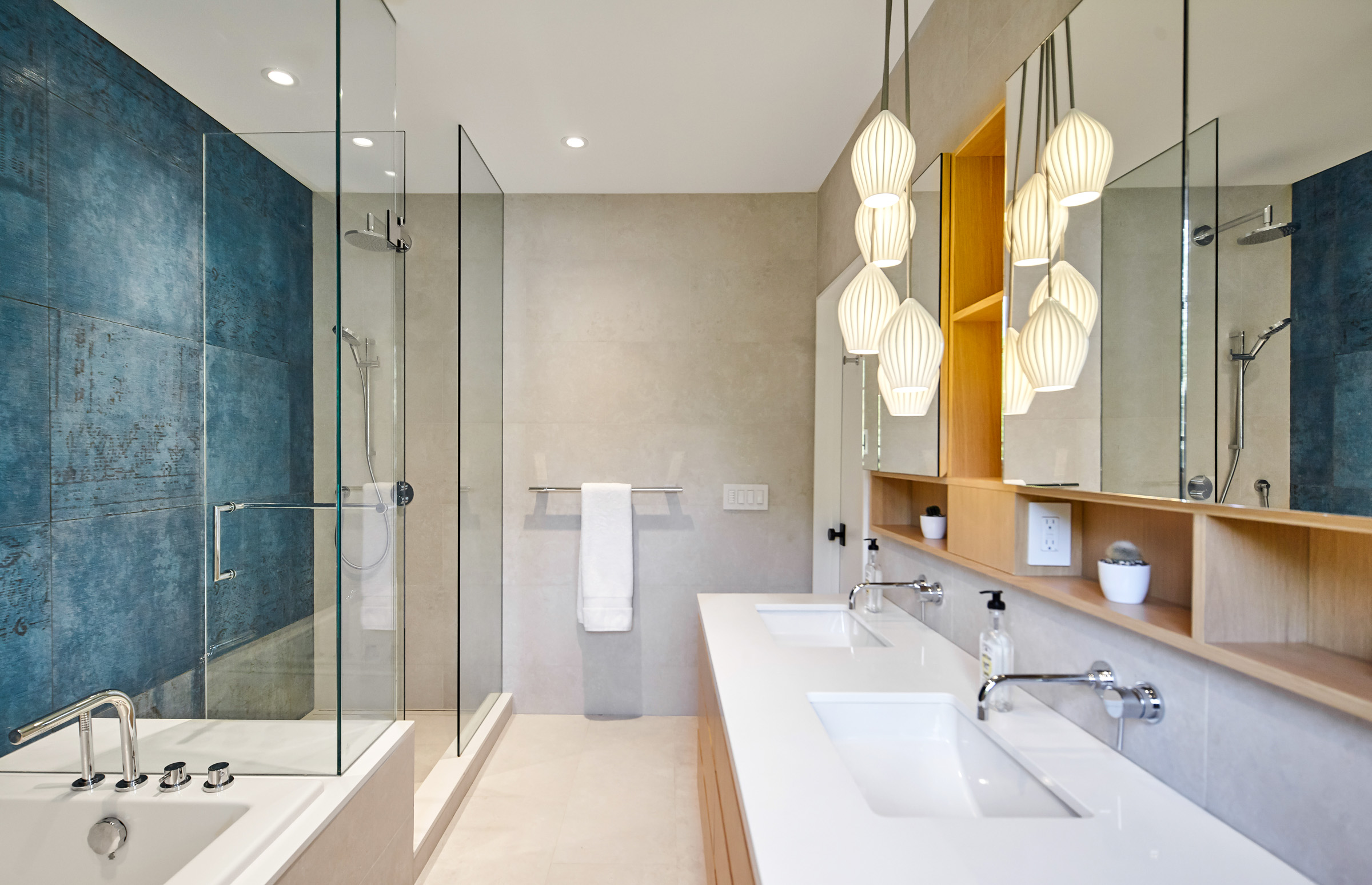 The master ensuite is a efficiently laid out and includes a floating double vanity, and plenty of storage space for toiletries in medicine cabinets recessed into the wall.