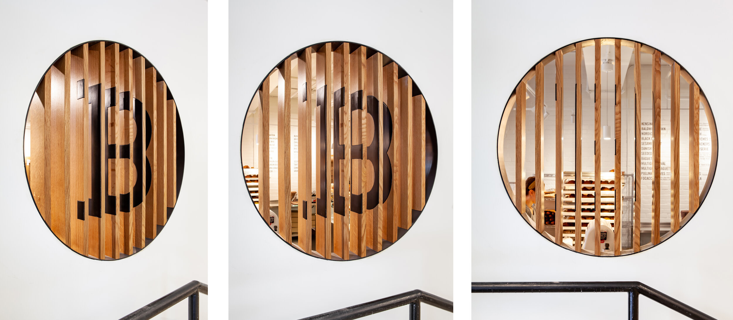 The entryway provides glimpses into the shop beyond through carefully composed wooden slats, without revealing the entire space at once.