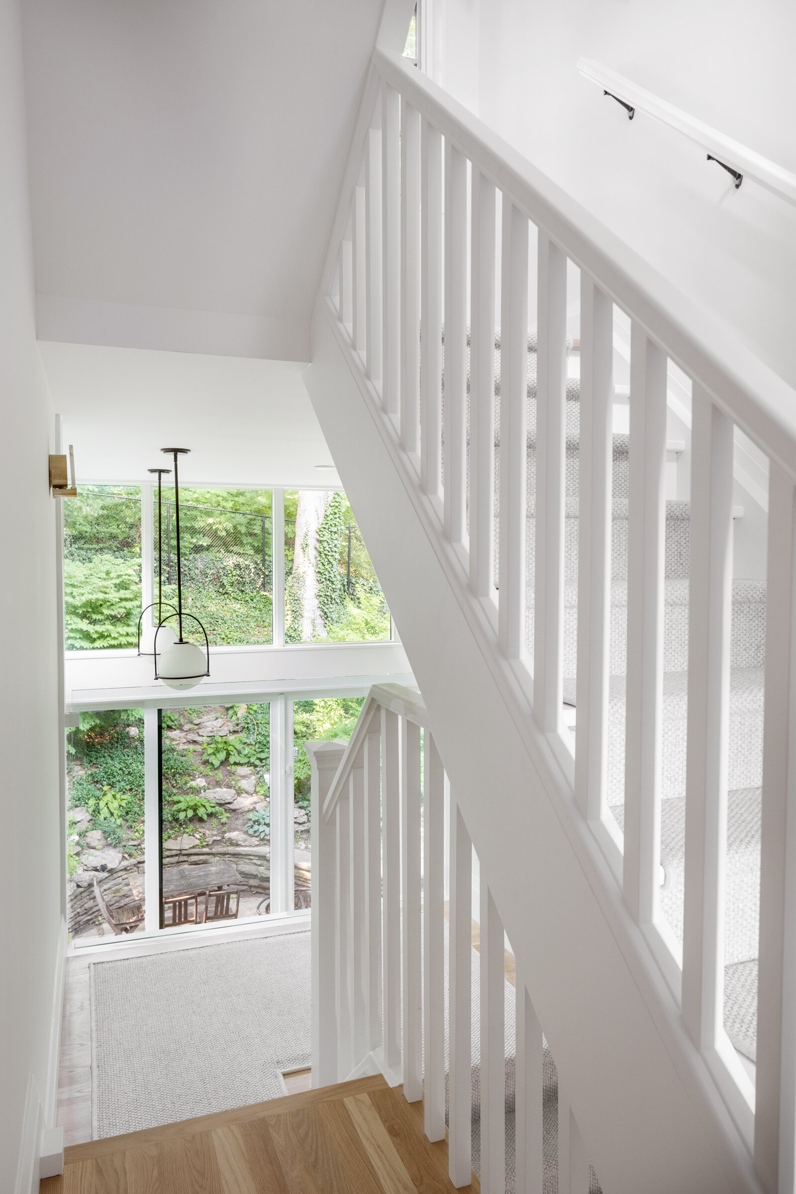 The double height space allows for views to the backyard from the second floor stair and landing, as well as the first.