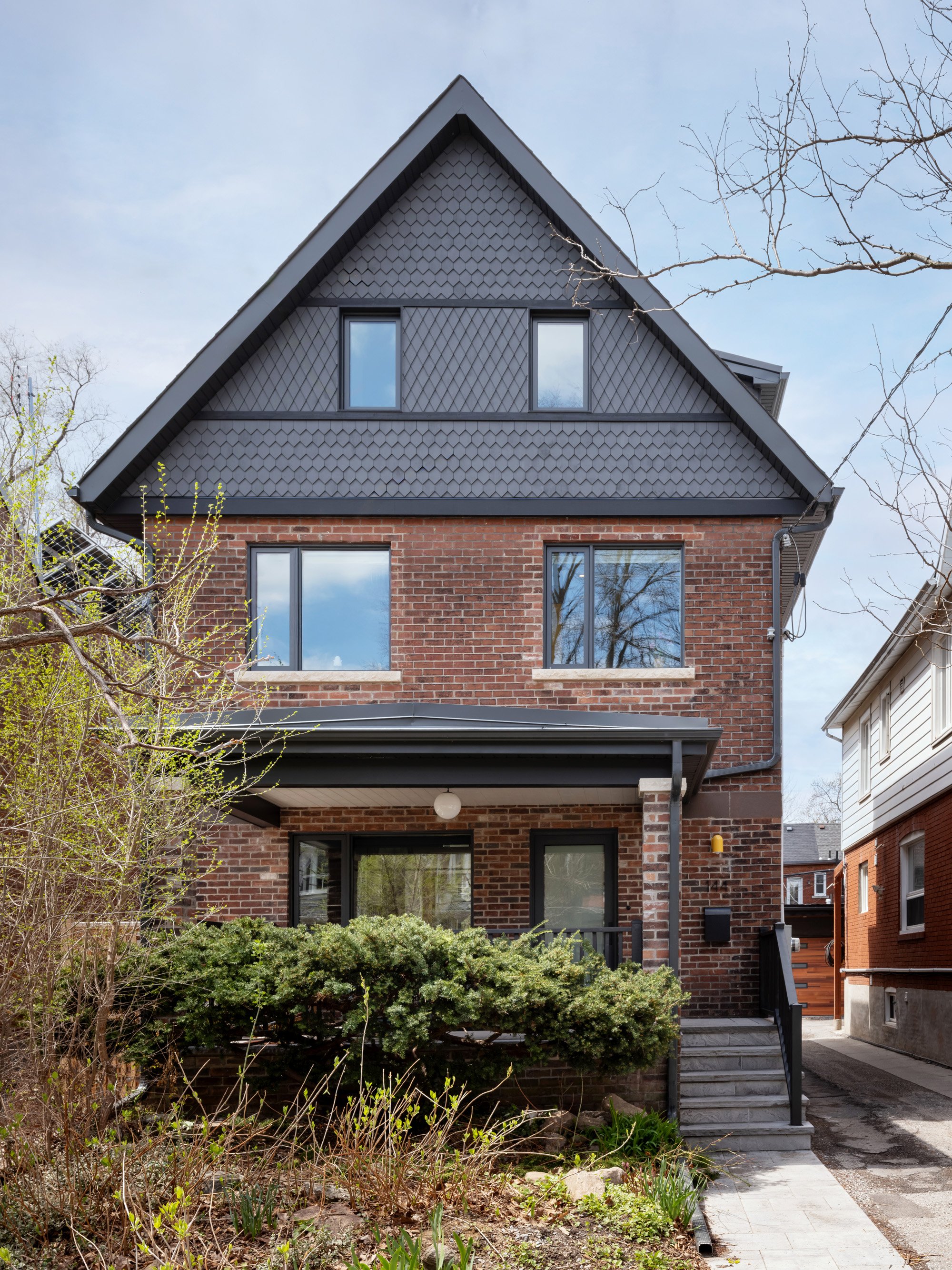 The front façade offers a clear view of the new third floor. The existing hip roof and partial third floor were removed, and a new gable roof with two large dormers was added. Although the new third floor offers much more useable space, the roofline