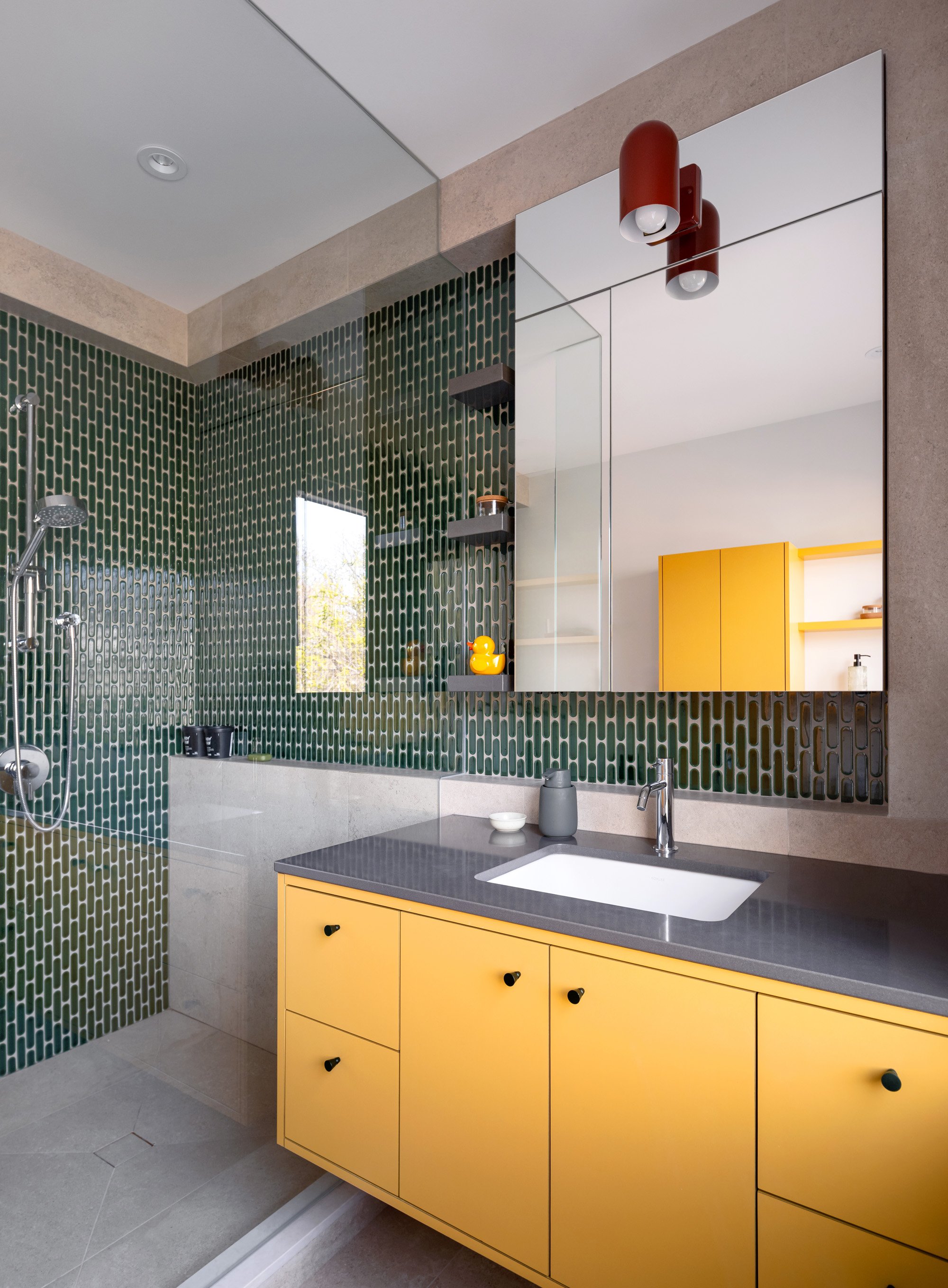 The kids’ bathroom embraces playful colour in a way that feels youthful and fresh. Low maintenance and durable materials are used throughout to minimize wear and tear, without compromising style.