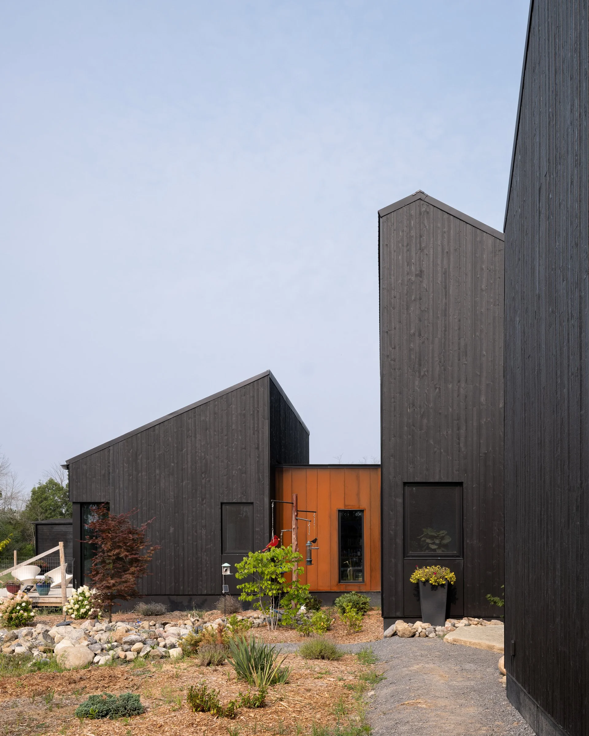  The slope of the rooflines of the volumes is carefully matched to appear continuous from some vantage points. As you move around the house on the exterior, the volumes tip back and forth from reading as one mass to revealing their composition as sep