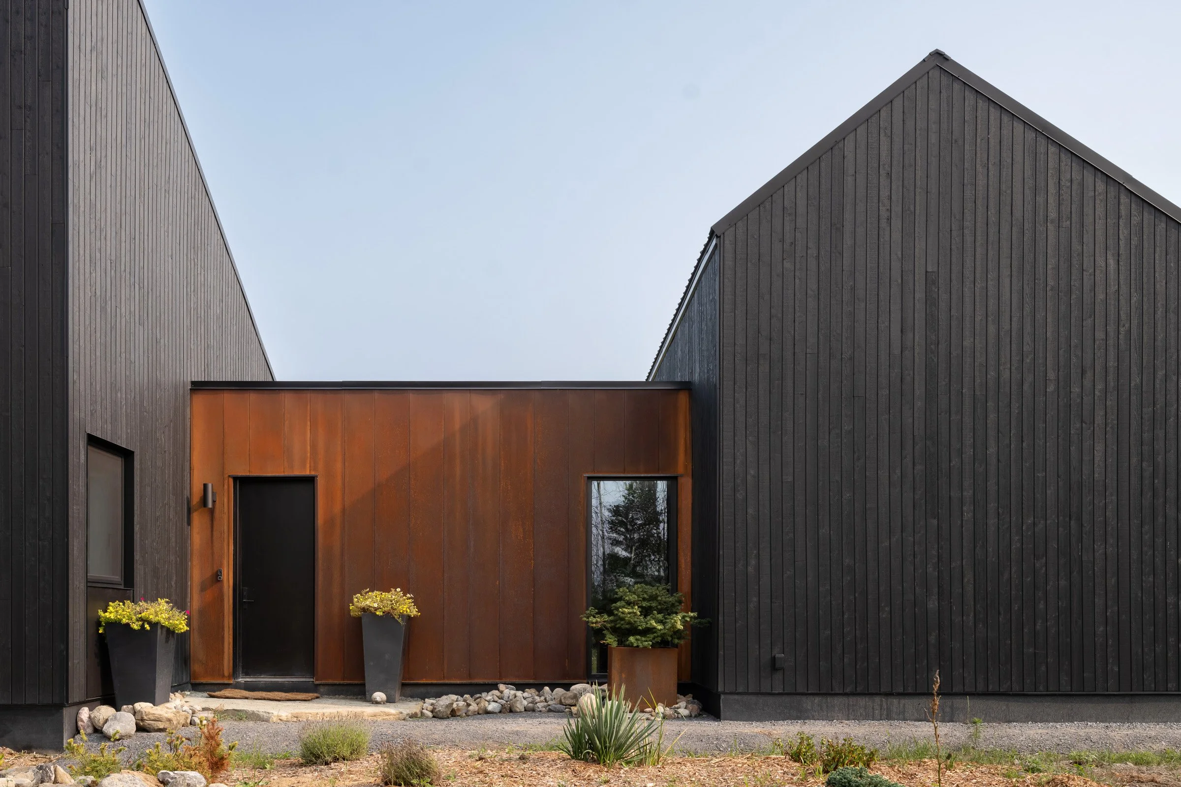  The corten cladding will continue to patina over time. The front door landing is a single enormous boulder sourced nearby. 