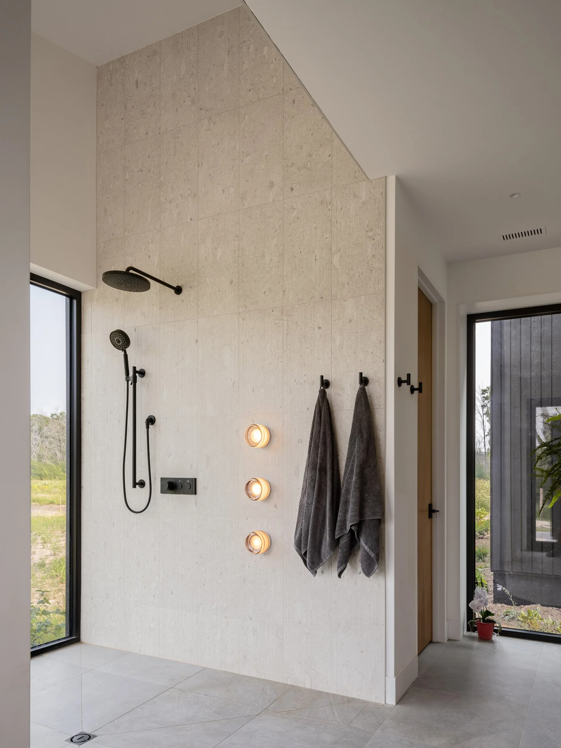  The water closet is tucked behind the shower in a separate room.  