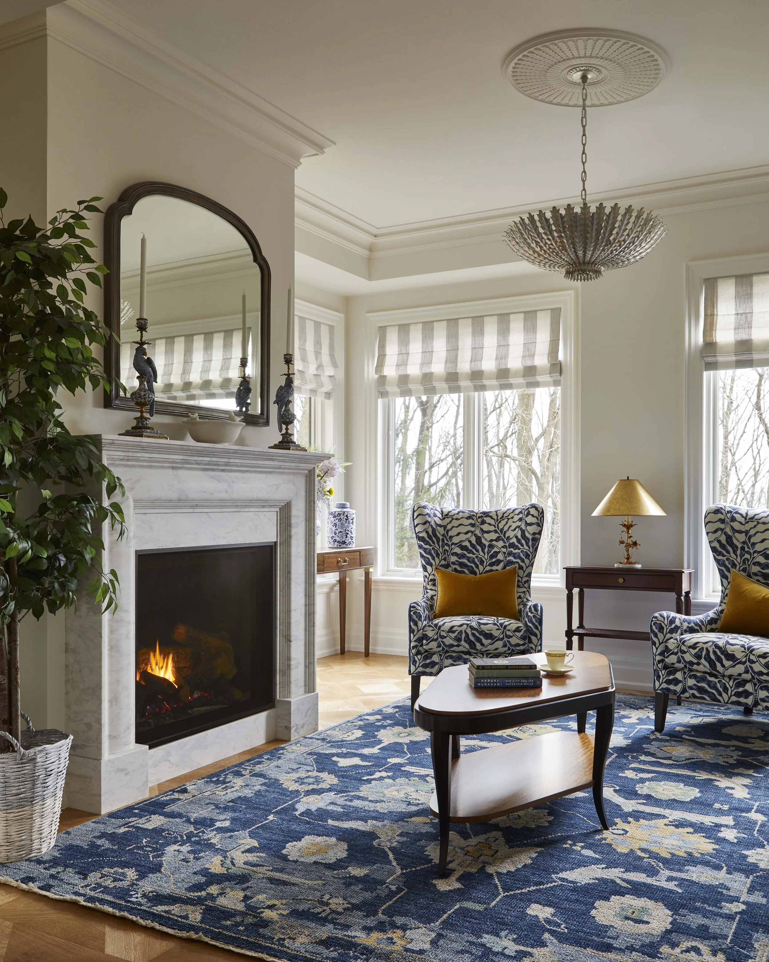  A new fireplace was added to the sitting room, located beside the main living room. While the primary living room is a grand, lofty space, this room is a cozier, more relaxed space to curl up by the fire. 