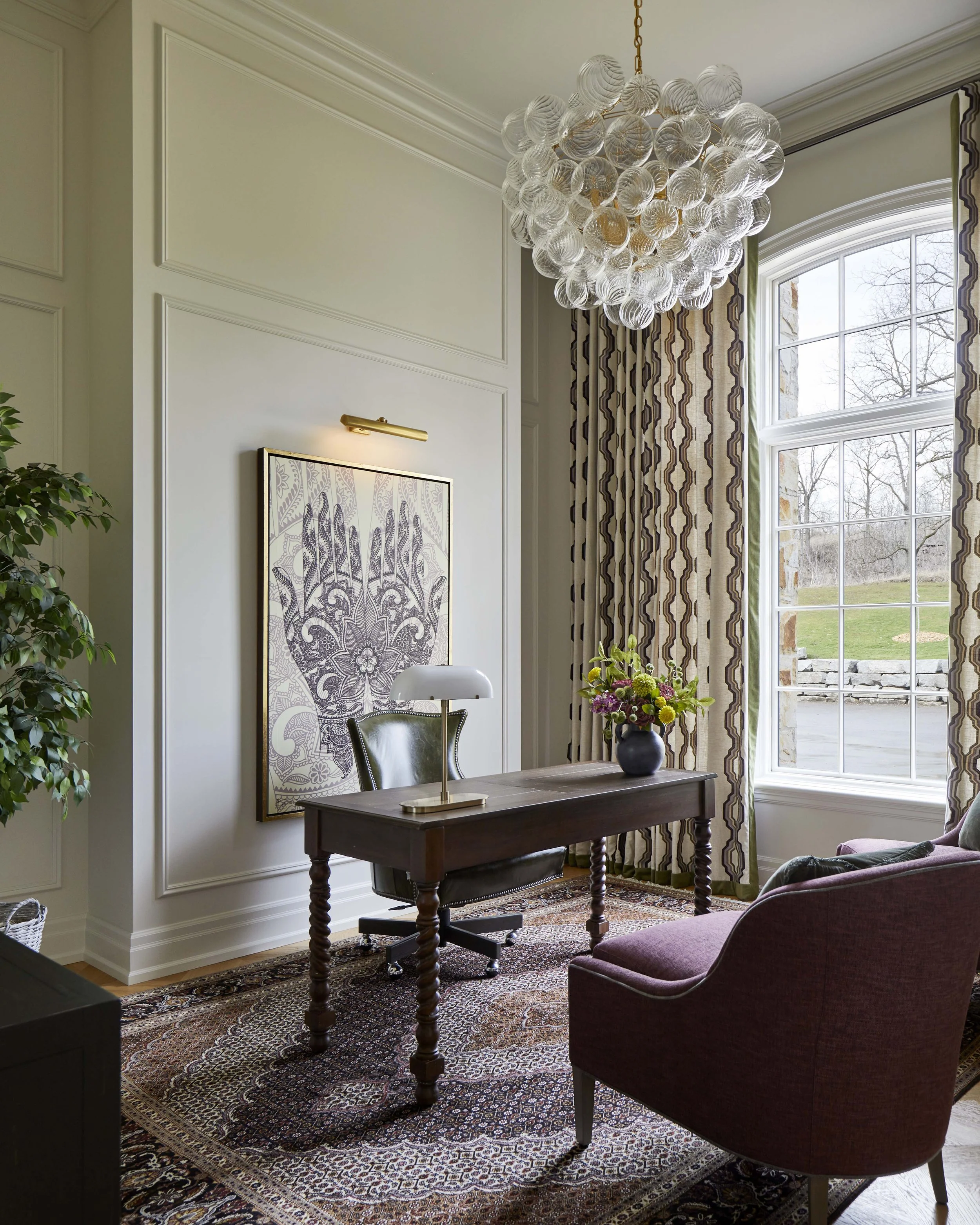  The home office is a separate space for work that has a generous ceiling height and earthy, grounded materials. 