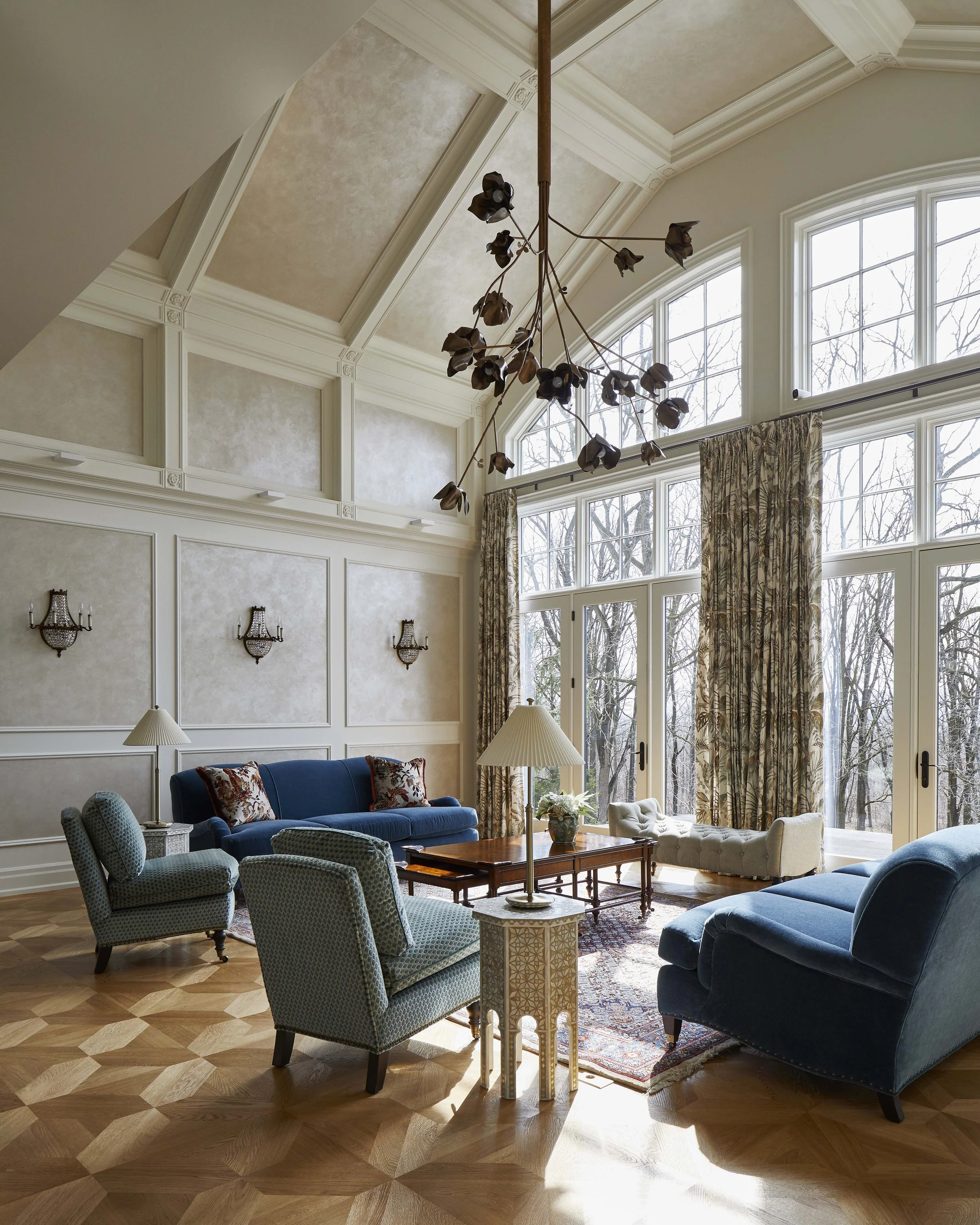  The main living room was an existing double height space with an awkward layout. A large opening in the wall was filled in to create a better flow and furniture layout. A new plaster coffered ceiling and wall panelling provide visual structure to th