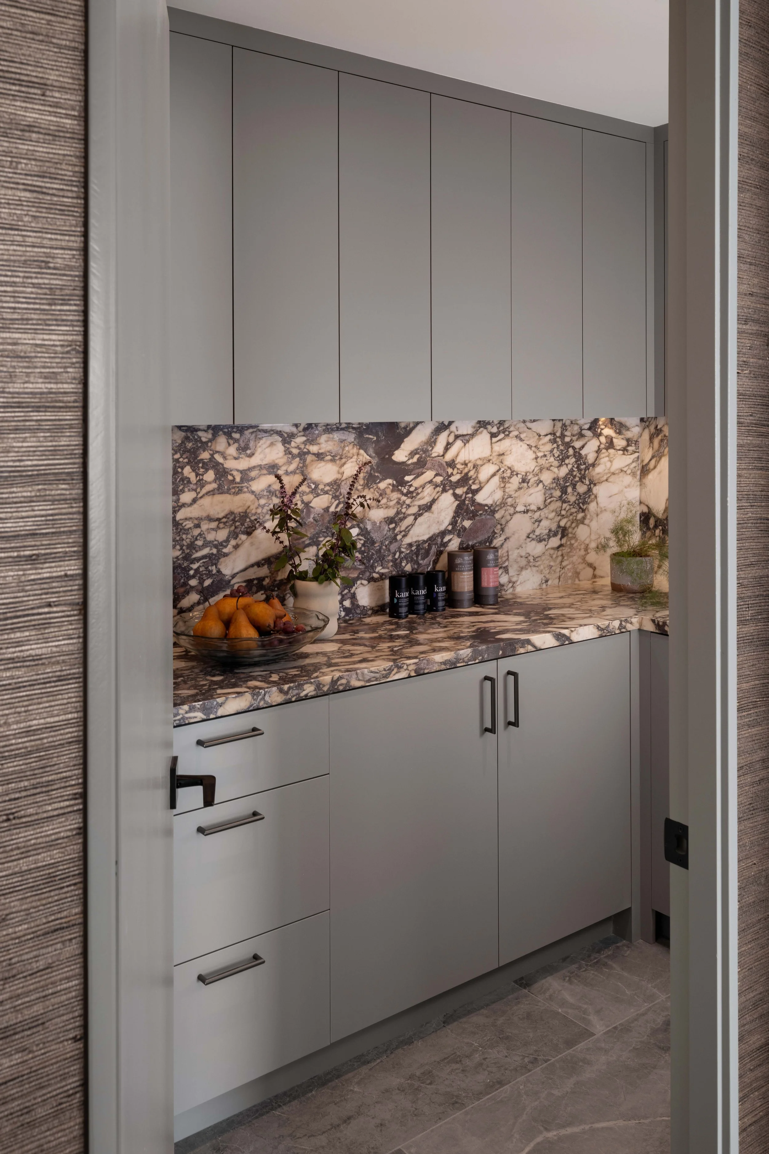  Just off the kitchen, a separate walk-in pantry was tucked behind the living room fireplace, offering lots of extra storage and counter space. 