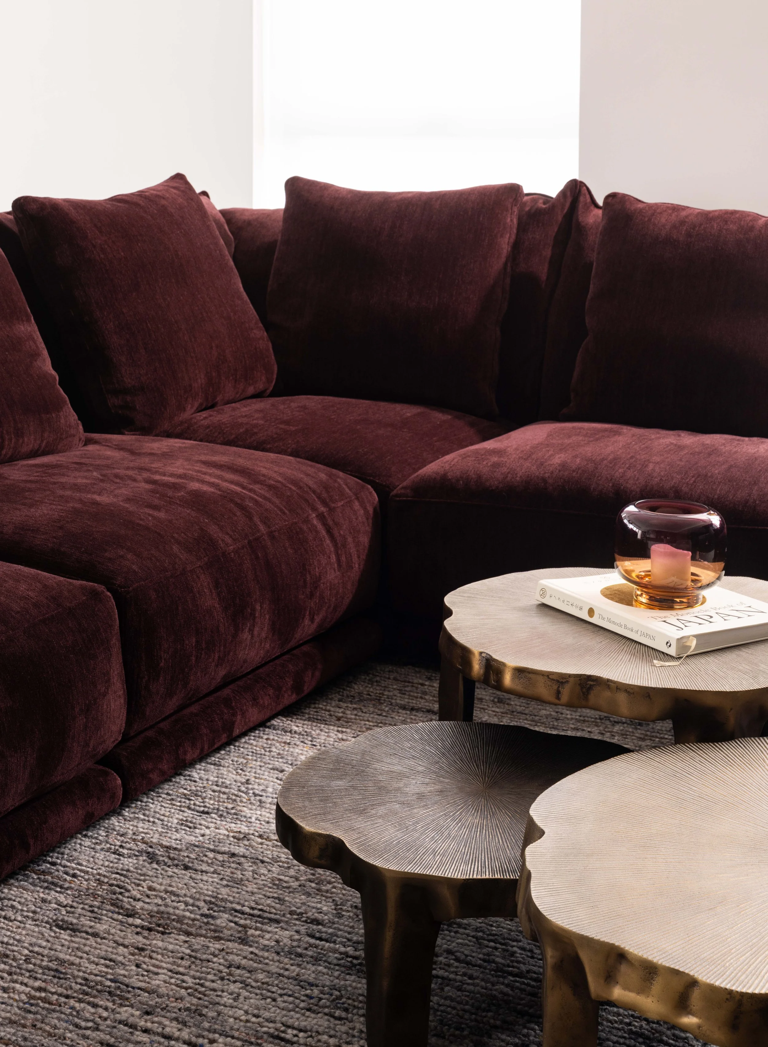  The colour of the marble is picked up in the large Montauk sectional sofa covered in a deep purple fabric. 