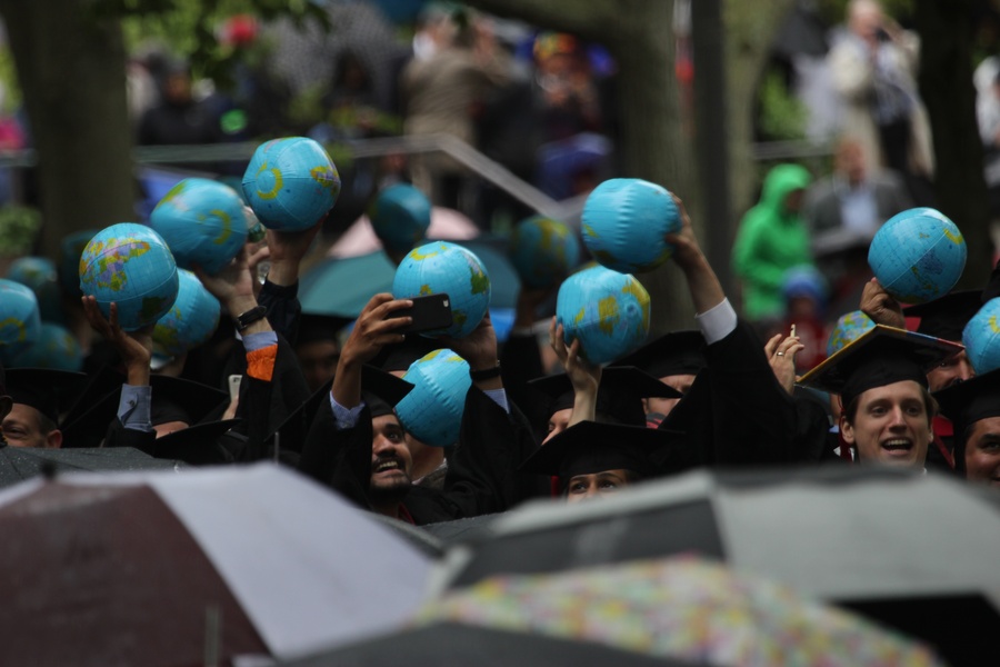 K-School graduates wave their globes. Photo by Lauren A. Sierra/The Harvard Crimson.