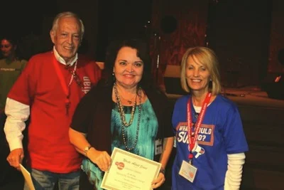 Carolana receiving an award for the song “Blessed by the Master’s Hands” from Sue C. and John Smith at the Write About Jesus Conference 2011.