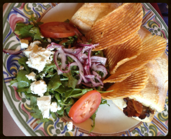  The New York: filet mignon, caramelized onions and cheese on baguette with additional arugula salad topped with goat cheese 