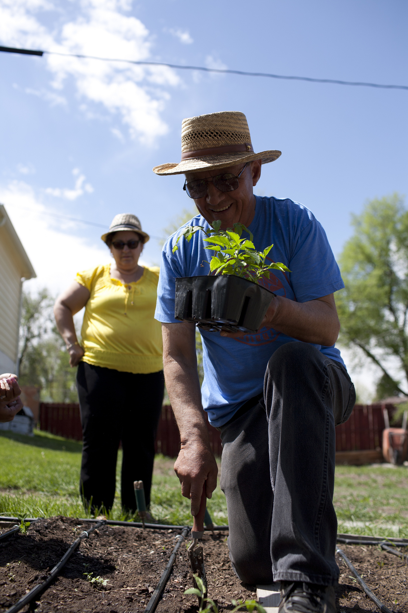 Promotor Christobal Rodriguez demonstrating how to plant peppers.