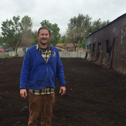 Josh Sampson digs into the soil at the Westwood Food Co-op