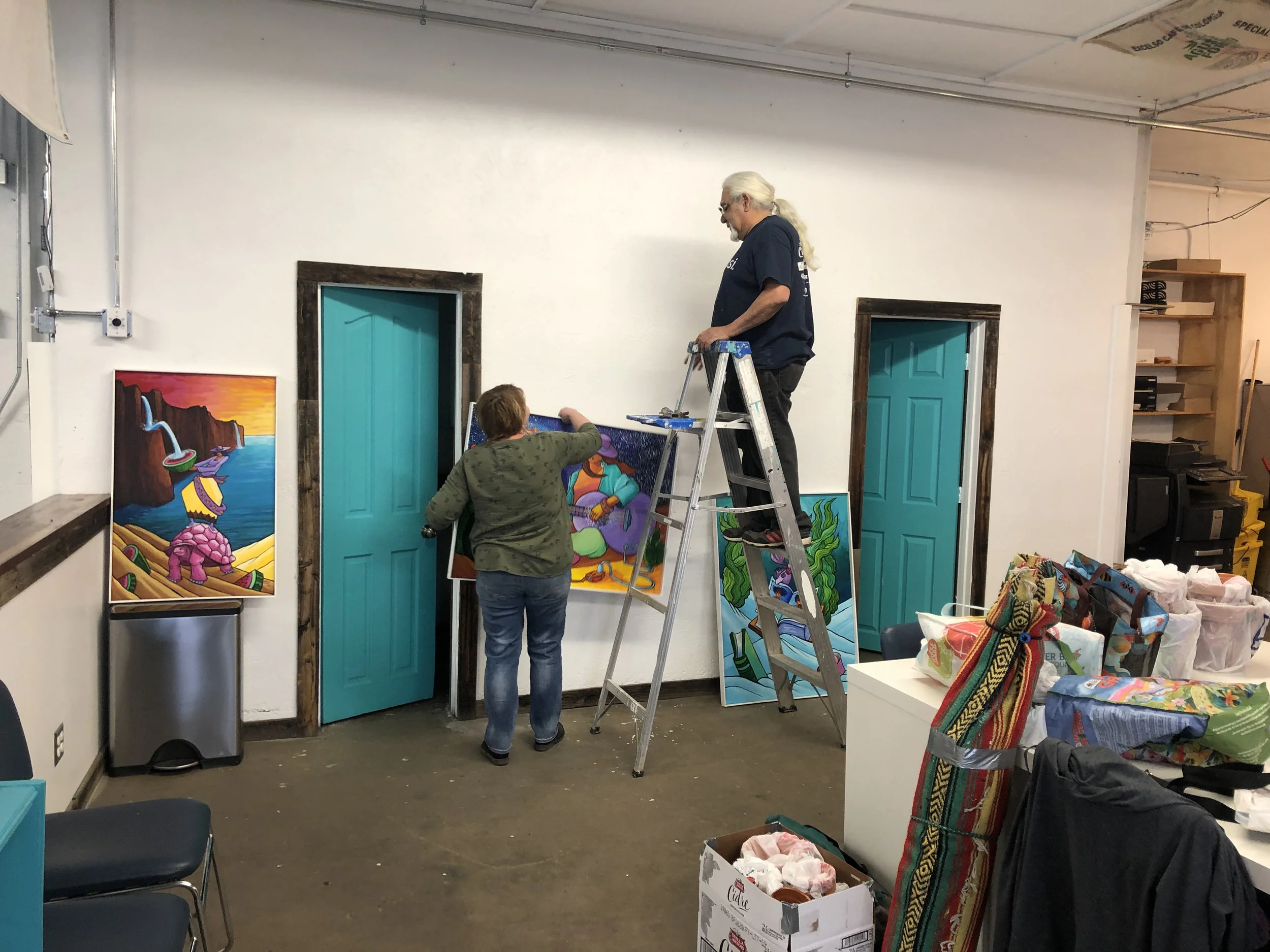 Daniel Luna hanging his show with Crystal O’Brien from BuCu West & Westwood Creative District