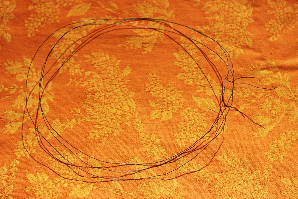 Leave extra 2.5 inches on each end, cut and twist the two ends together.