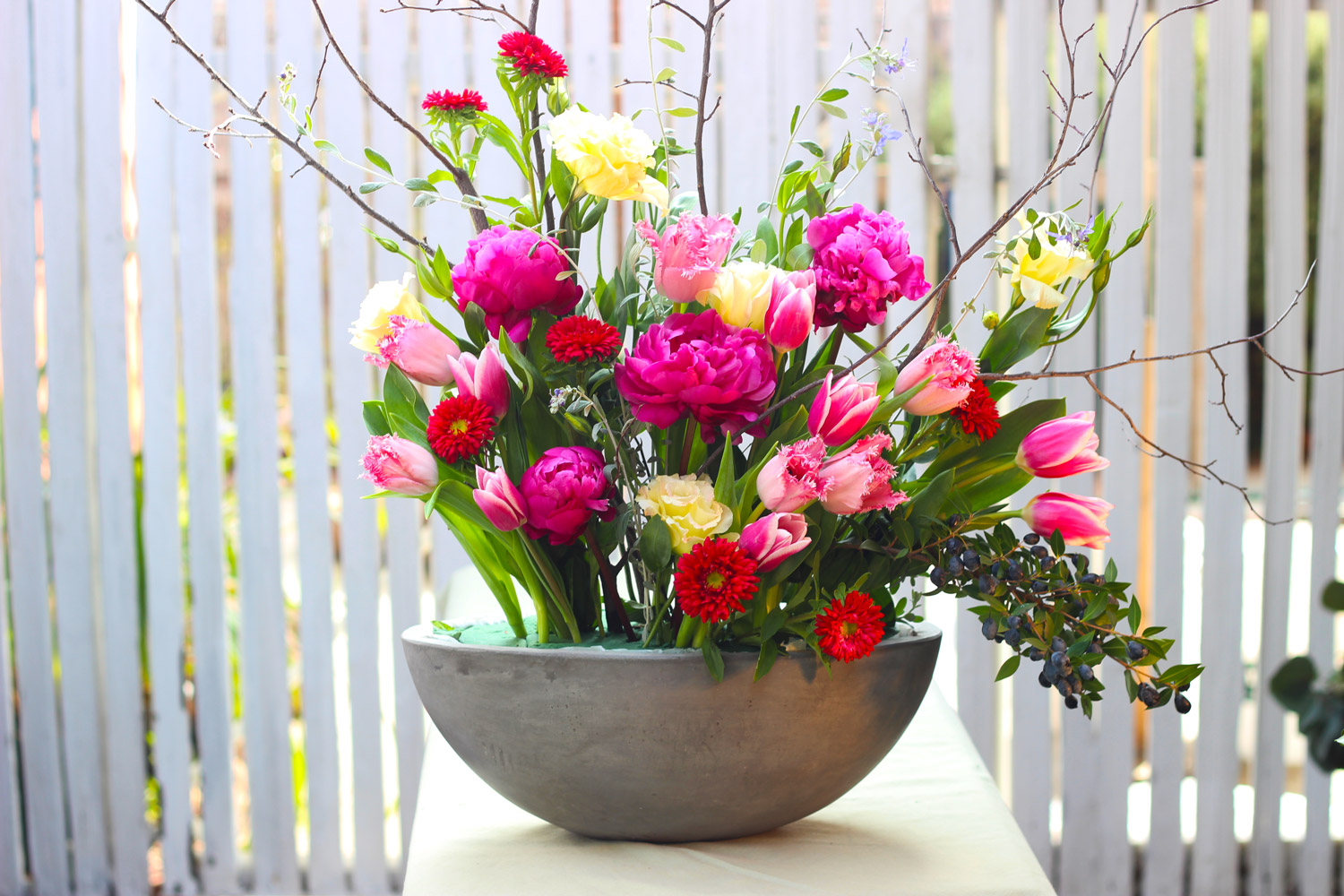 The line of the flowers completes the circle then sweeps down to the left.