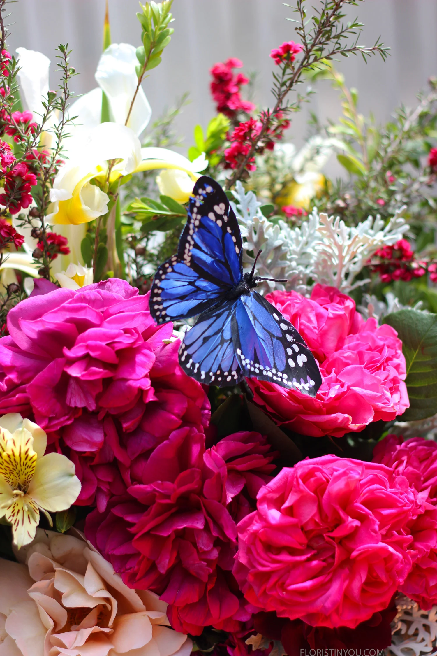 Set butterfly in flowers with wire and pick behind.