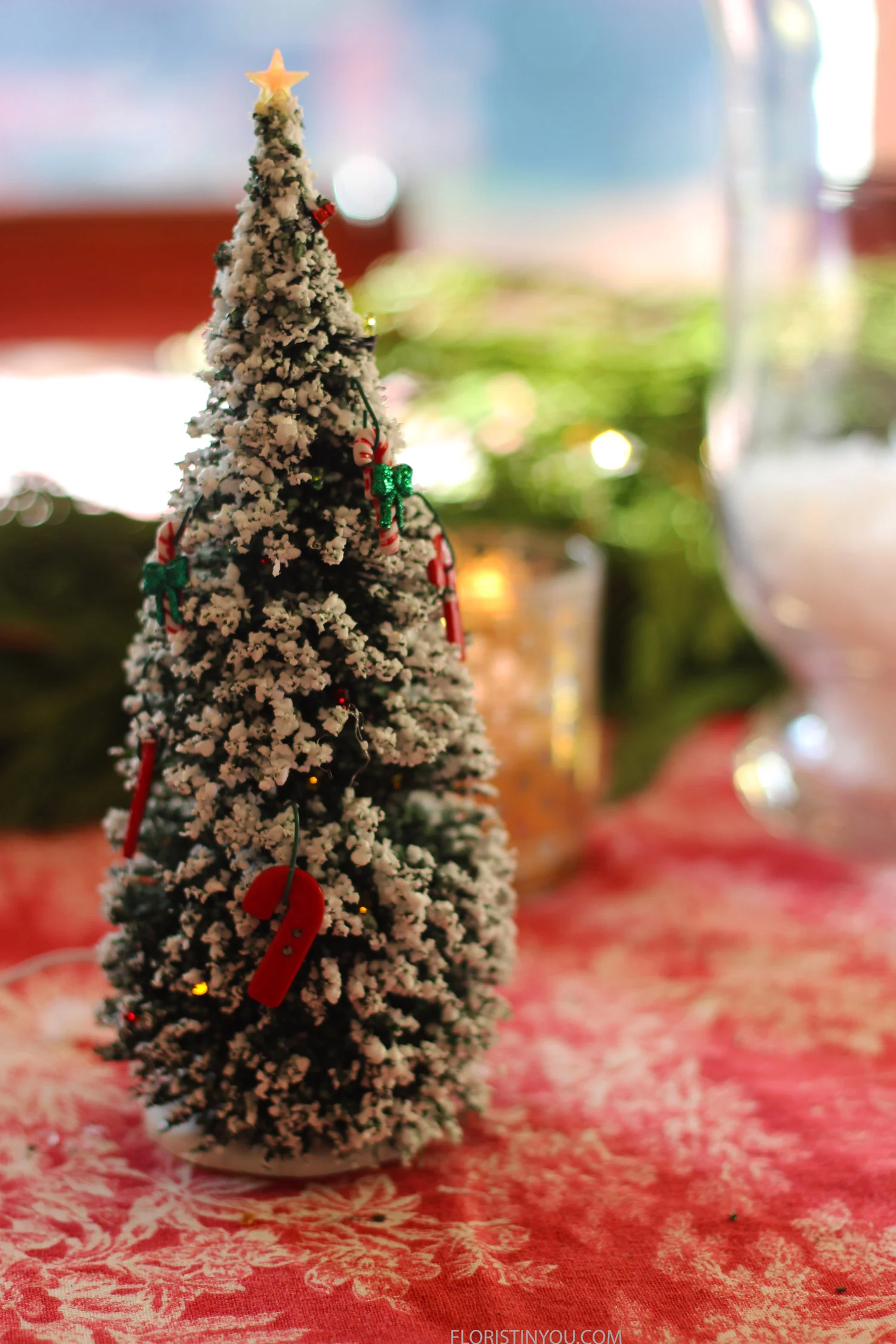 Hang ornaments on tree.