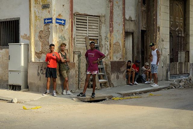 At other times, the ball players recede onto the sidewalk on Calle Animas into their &ldquo;dugout,&rdquo; joining the spectators perched on a stoop. #cubanlife #cuba #havana #goinghome #centrohabana #streetphotography #streetlife #playinginthestreet