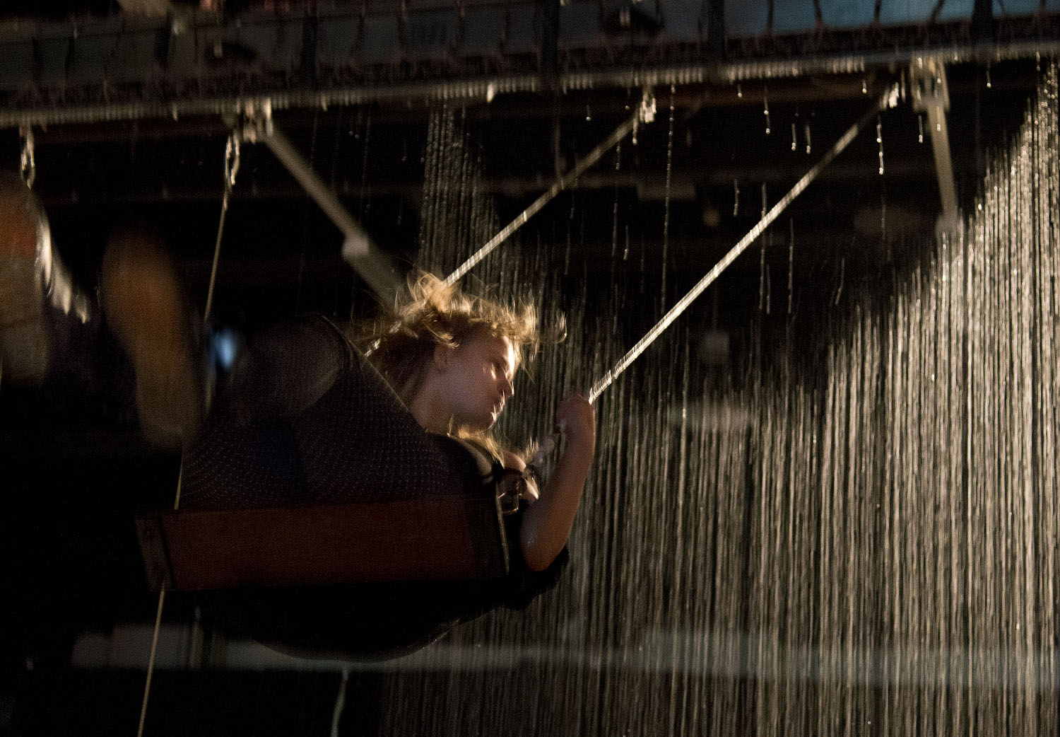 girl on waterfall swing at STRP Biennial Eindhoven