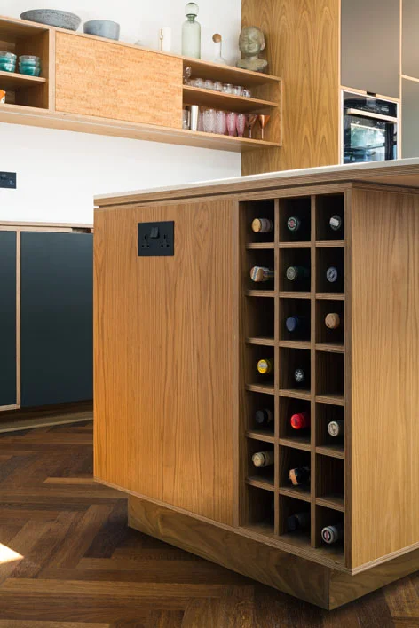 Bespoke Plywood Kitchen Island Wine Rack by Uncommon Projects