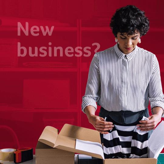 Young woman with curly hair, standing at a desk, looking at papers, with a red background and white text and icons. Sample of social media video template for Canada Life