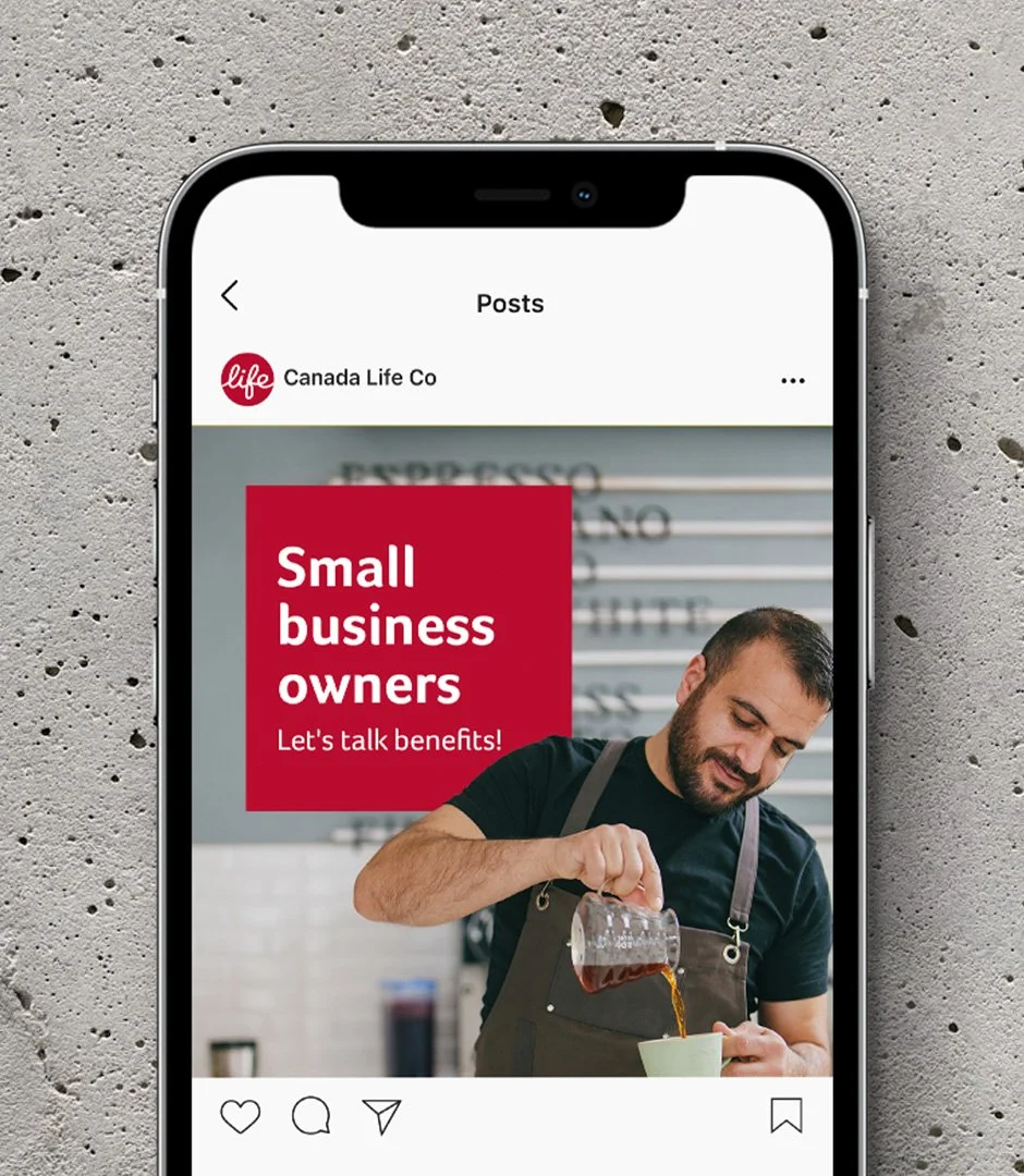 A smartphone displaying an Instagram post promoting benefits for small business owners from CanadaLife, featuring a man pouring coffee into a cup, set against a textured concrete background.
