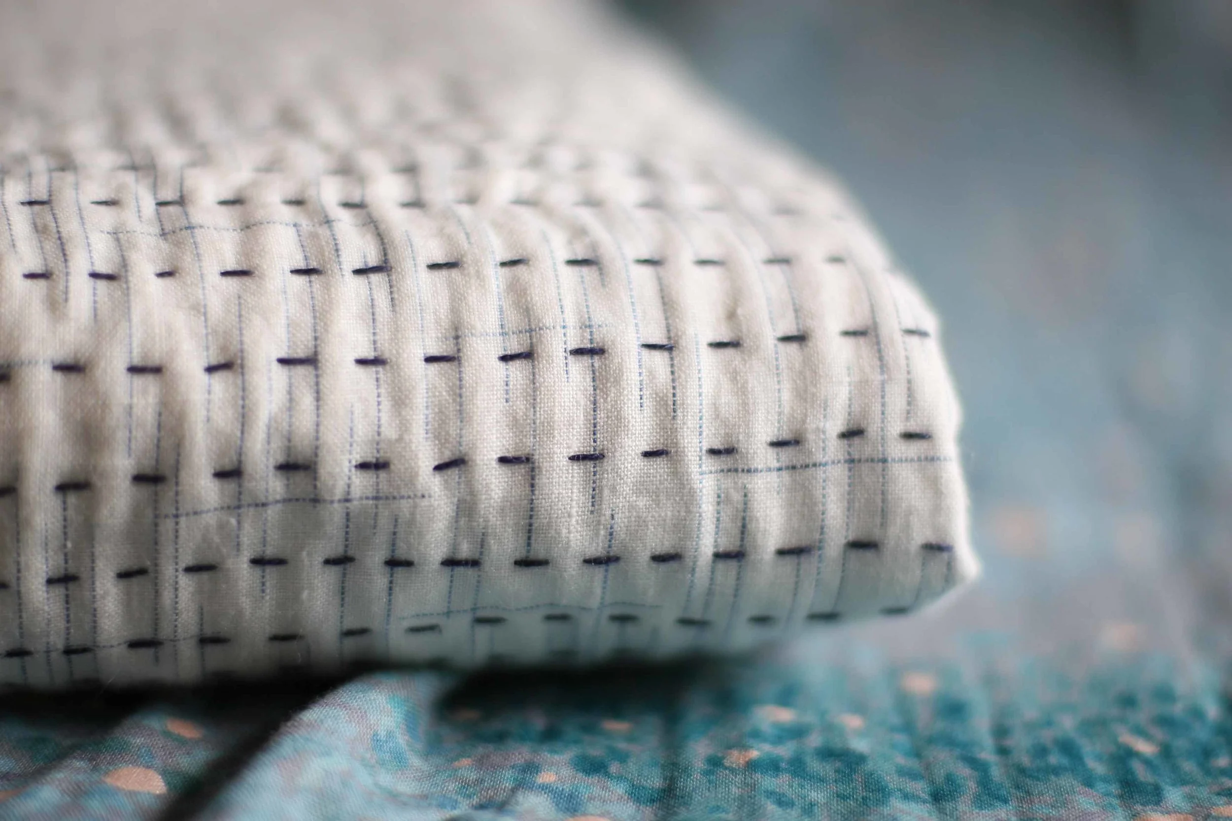 The lovely hatching on the linen runs vertically and horizontally, which beautifully shows just how distorted my stitching has made the linen. Would get you a better photo but it is late. You can see it in the top two rows of stitching that are in focus. It is much worse in the middle of the quilt.