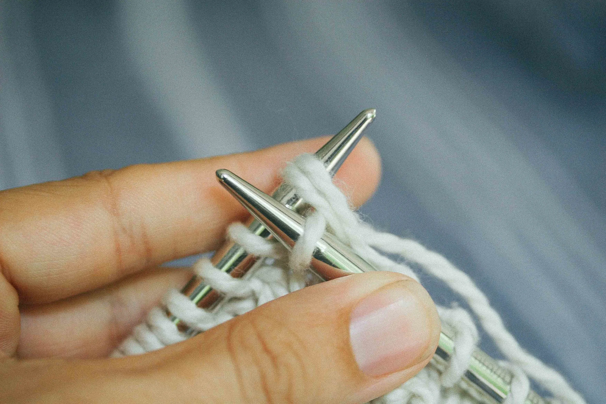 The single loop is pulled through the two loops from back to front.