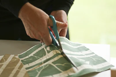 Cutting some gorgeous oldschool Ink & Spindle fabric.