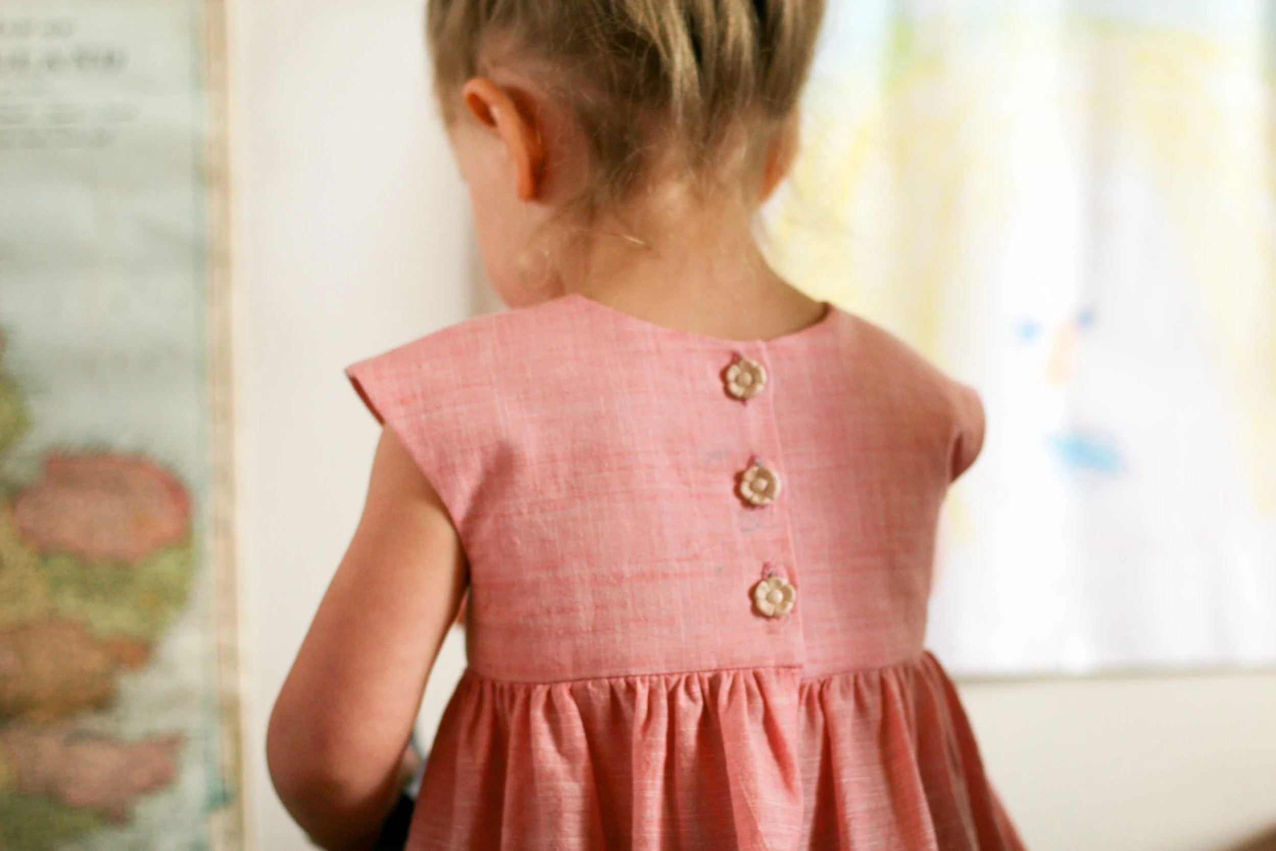 I've realised as I have been posting these photos that actually I really really love the back view of the frock. Pretty buttons make it!