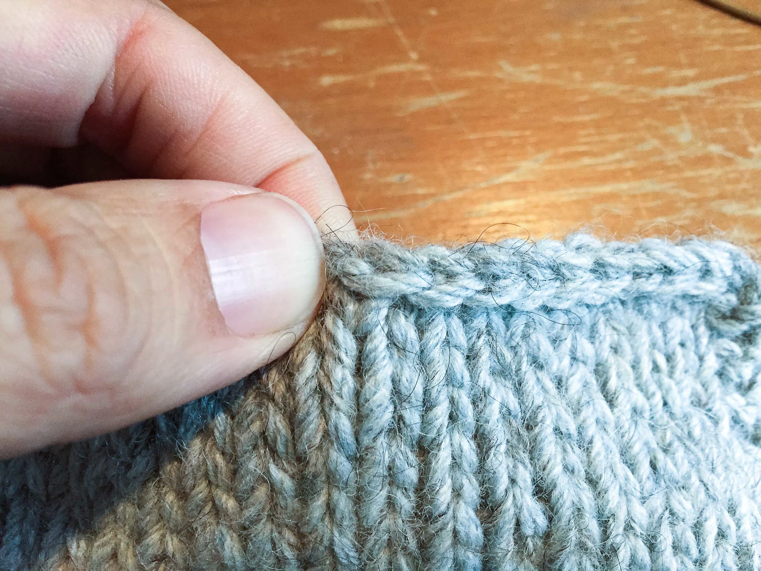 The left side of the V is sitting right next to my thumb nail just below the cast on edge.