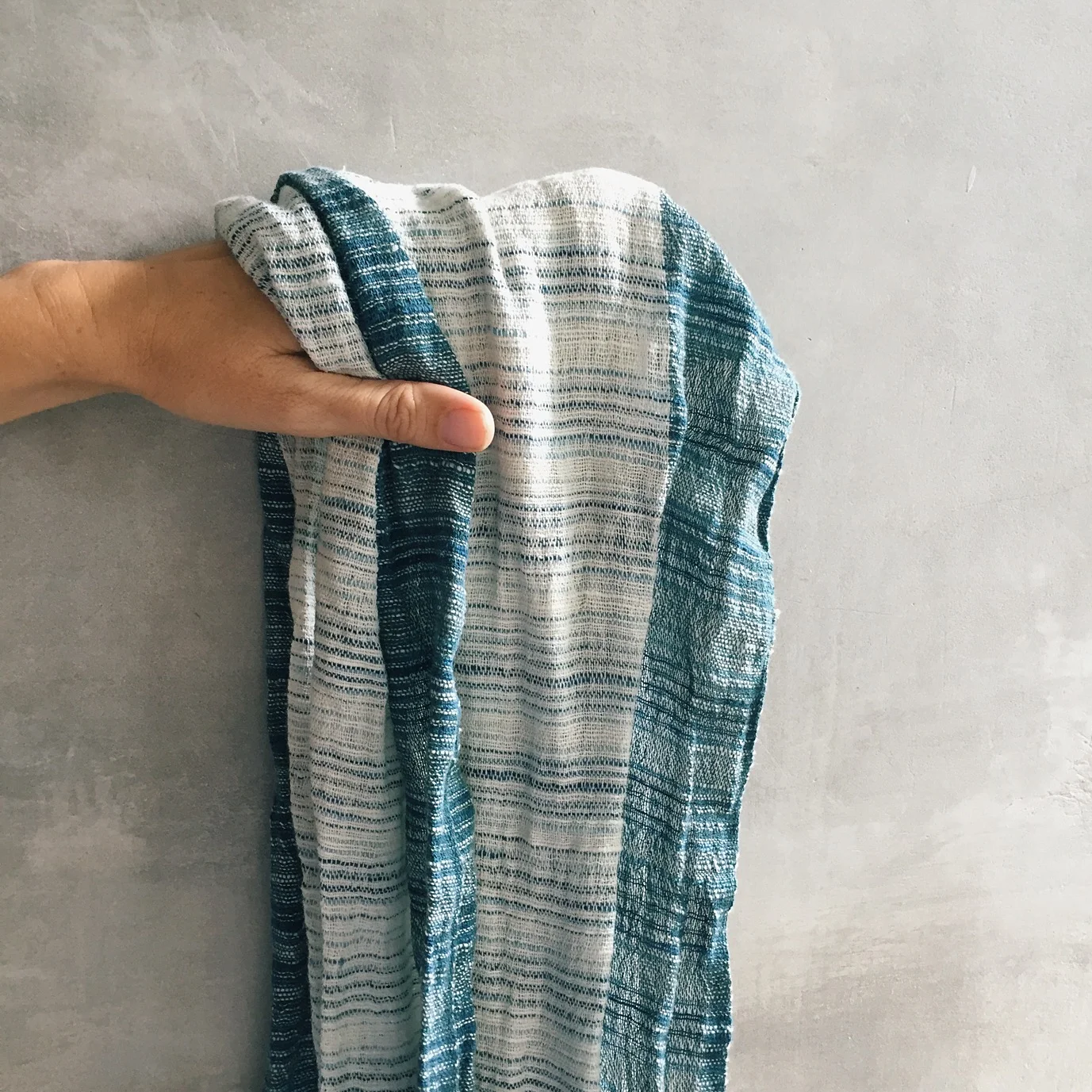 From it's tag - This Balinese handspun hand woven shawl is designed by Breeze, a small cottage industry of balinese artists. The natural dyed threads are from plants such as indigo. It is hands-on cotton too.