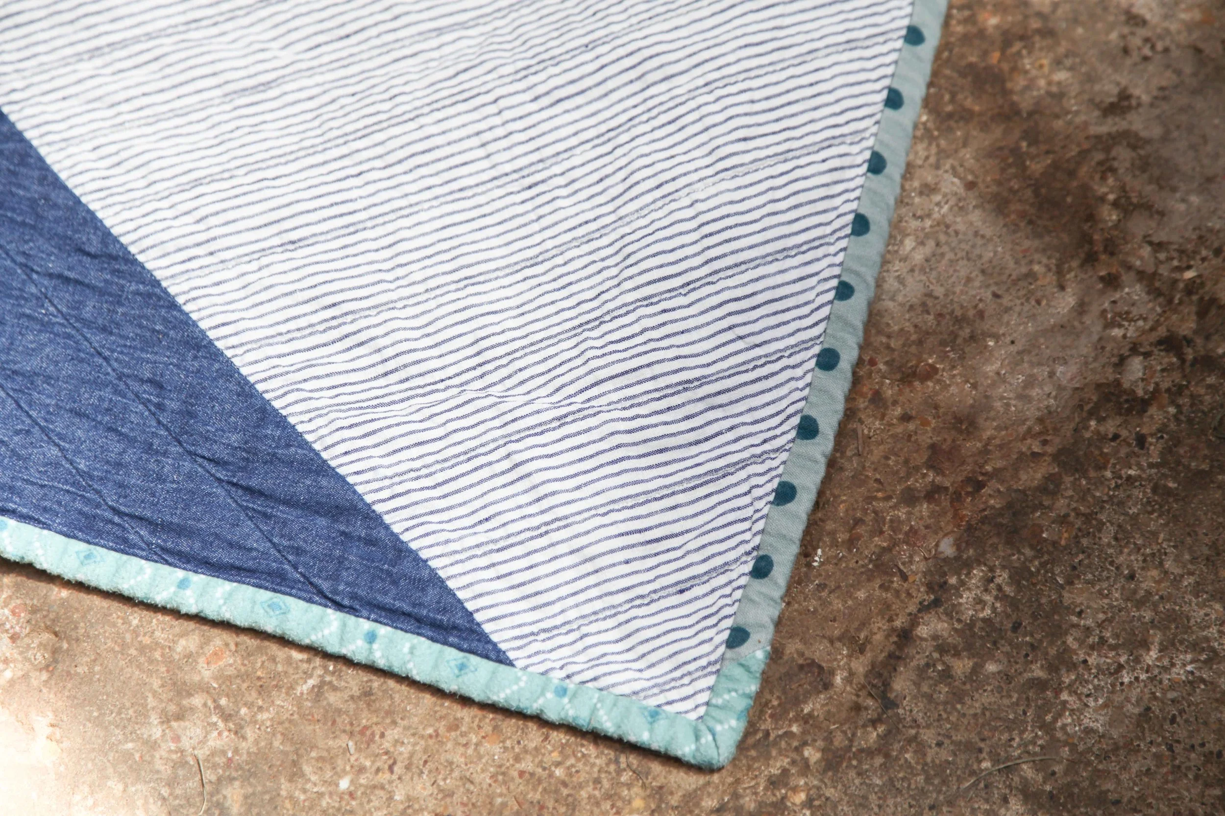 Biasing and lumps on my little boy's quilt. And yes some of that binding is flanellette. And the spots are a thick cotton/linen blend. Not a quilting cotton in sight :).