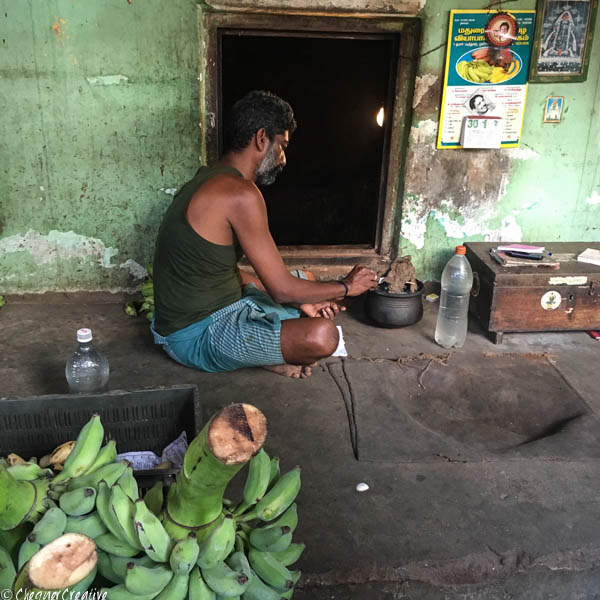 Lighting a cow dung fire to put with bananas in the 'banana cave' to ripen them Madurai Banana Market