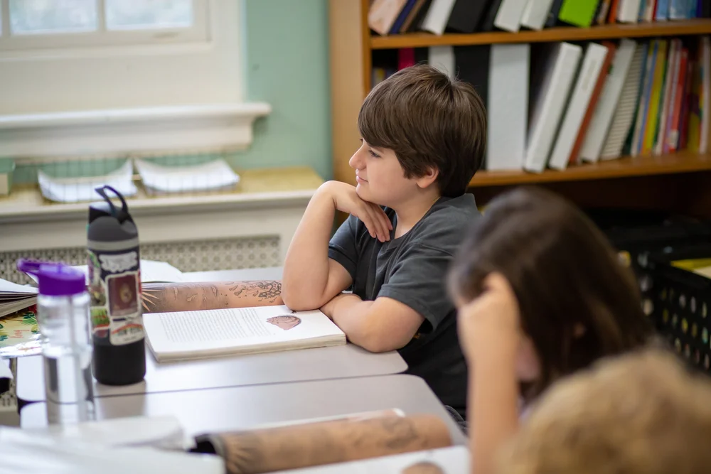 A student listening at a seminar table