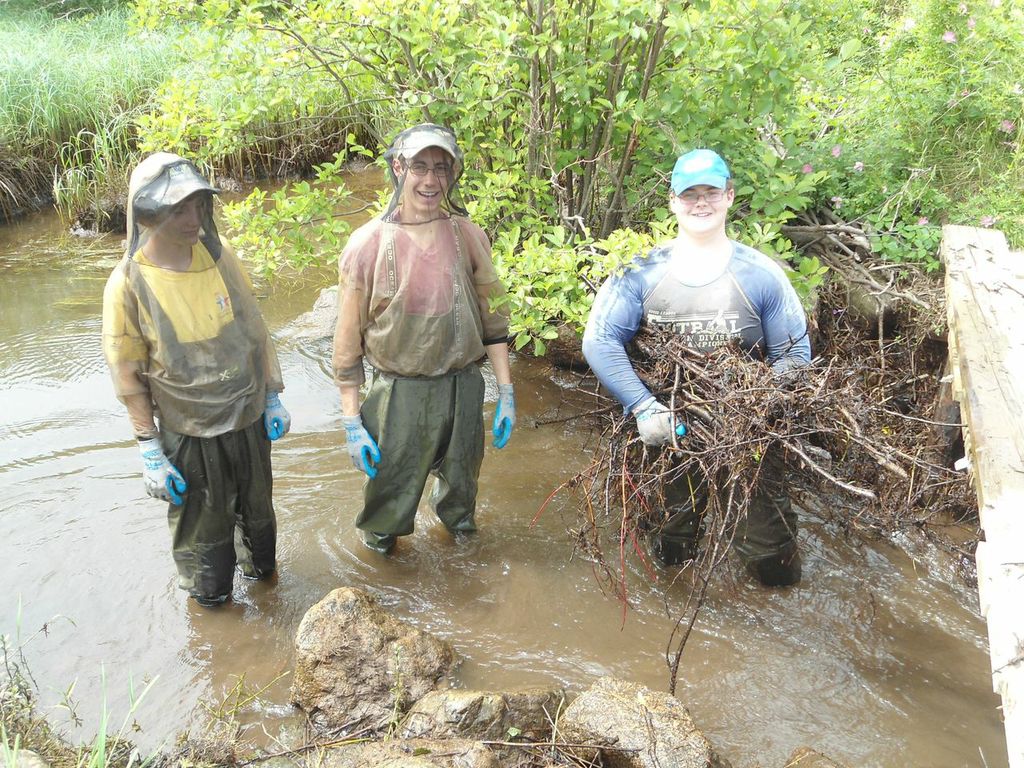 Members of the Cheticamp River Salmon Association restoration team: Antoine Aucoin (left), Kyle Lefort (centre), and Jeremy Camus (right), while removing a beaver dam on Aucoin's brook.