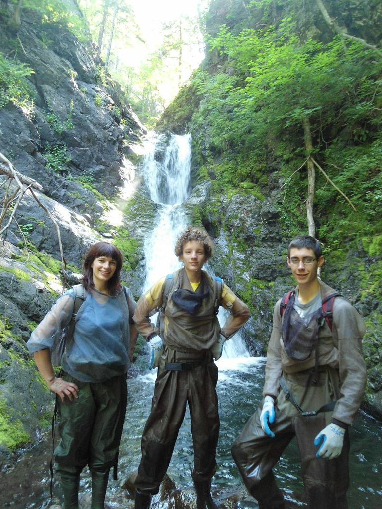 Members of the Cheticamp River Salmon Association restoration team: Jillian Baker (left), biologist, Antoine Aucoin (centre), and Kyle Lefort (right) stop for a picture while doing monitoring/surveying work on Aucoin's Brook.