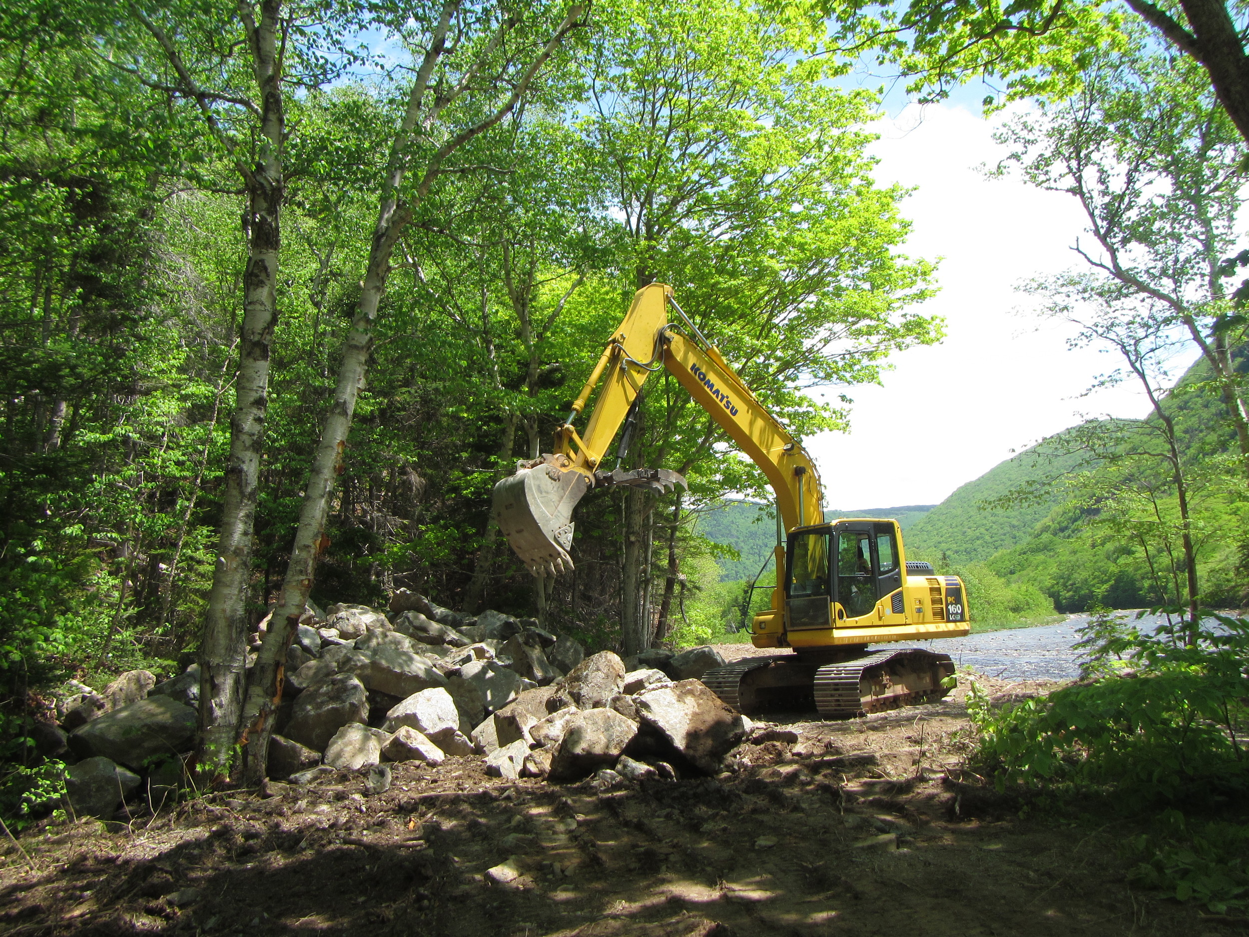 Moving boulders into the pile.