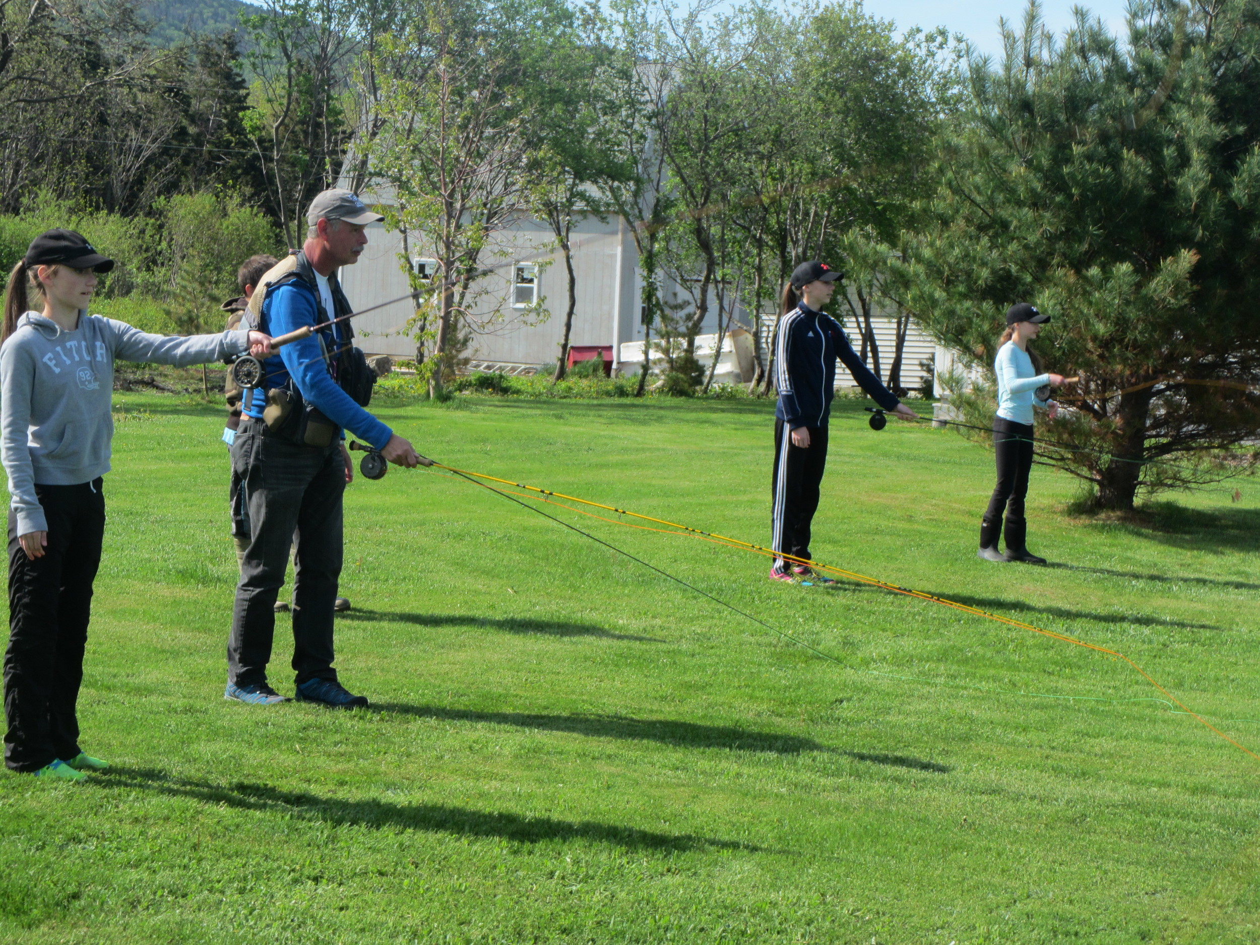 Lewis shows the grade 7's how to dry cast before tying on the real flies.