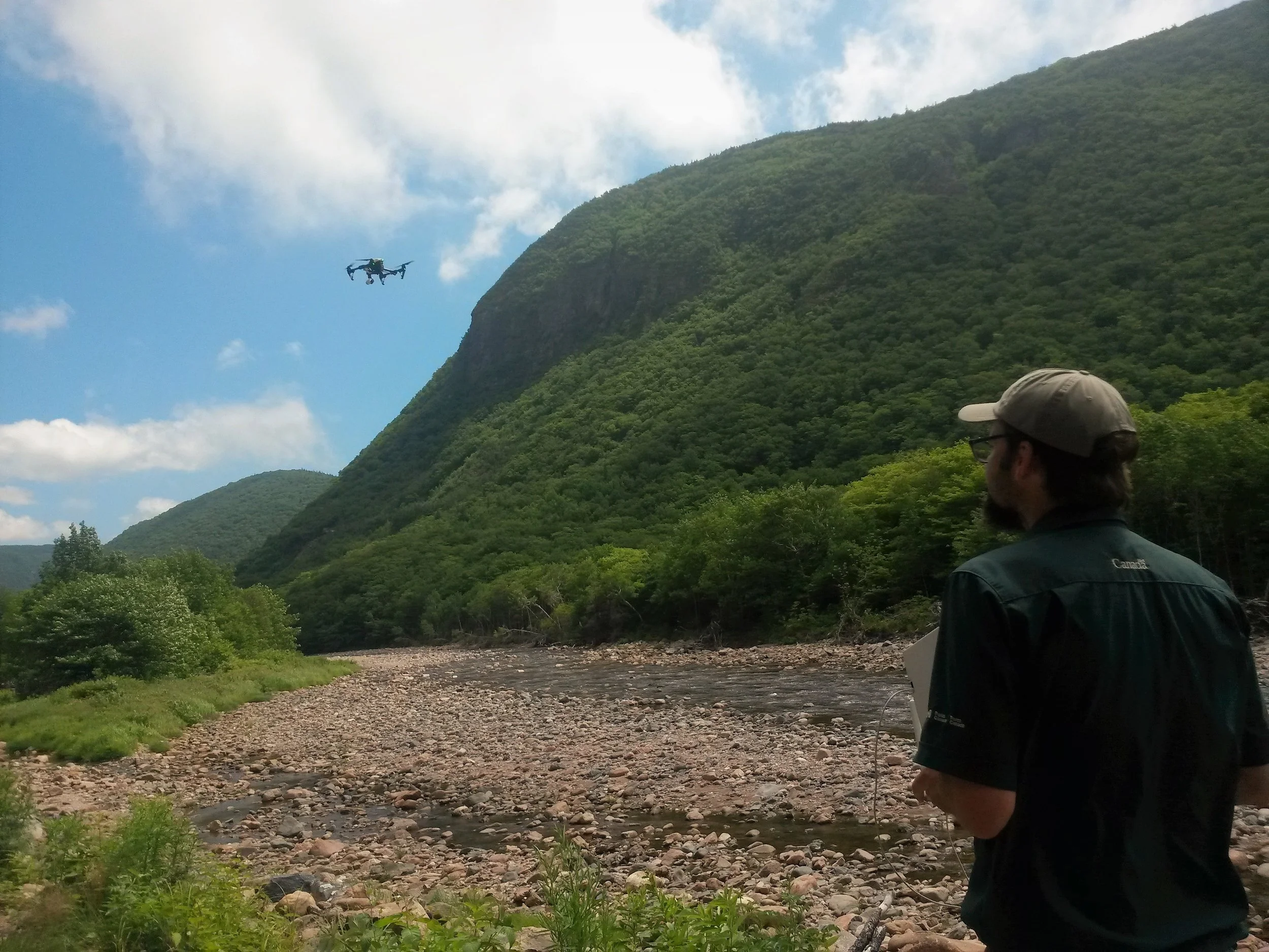 Geomatics Technician Michée Lemieuxwith CBHNP flies a drone over project work sites prior to the start of instream work.